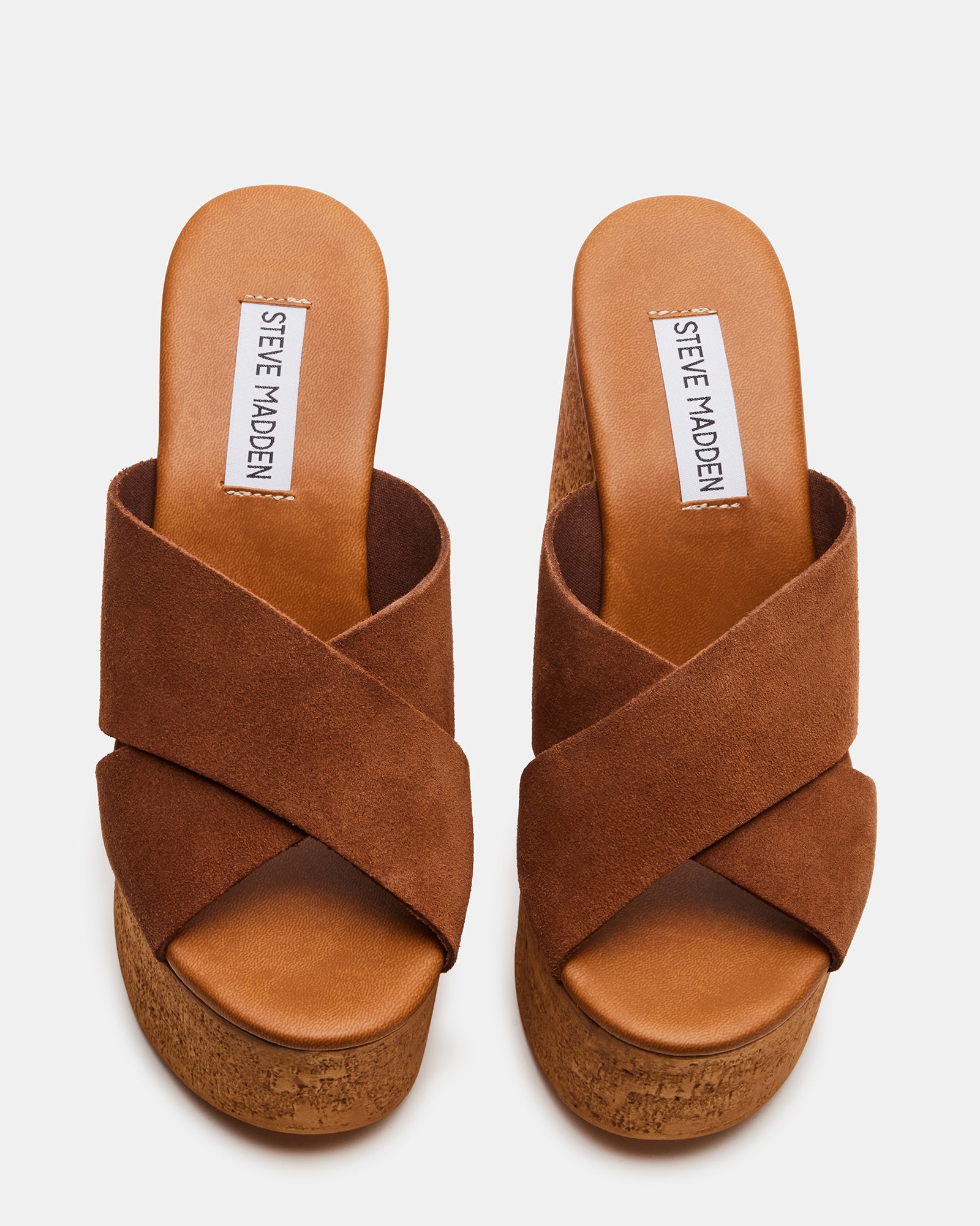Close-up of block heel shoes sandals showcasing suede texture and criss-cross design.
