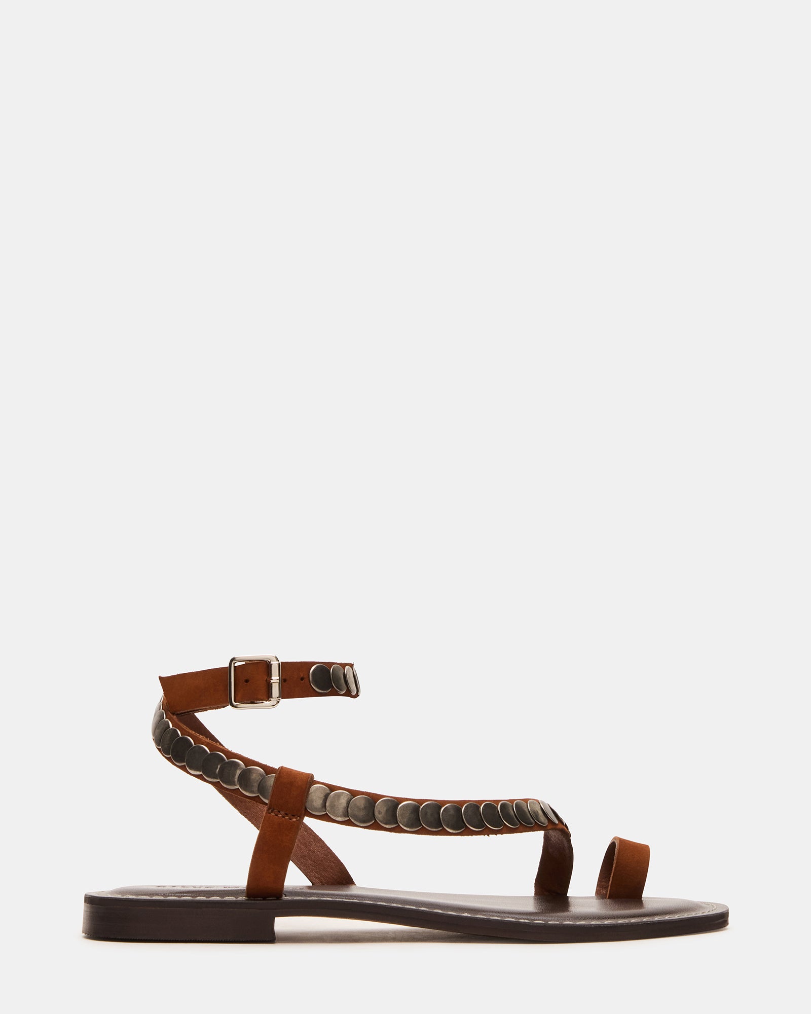 Overhead view of black flat sandals styled with summer linen outfit