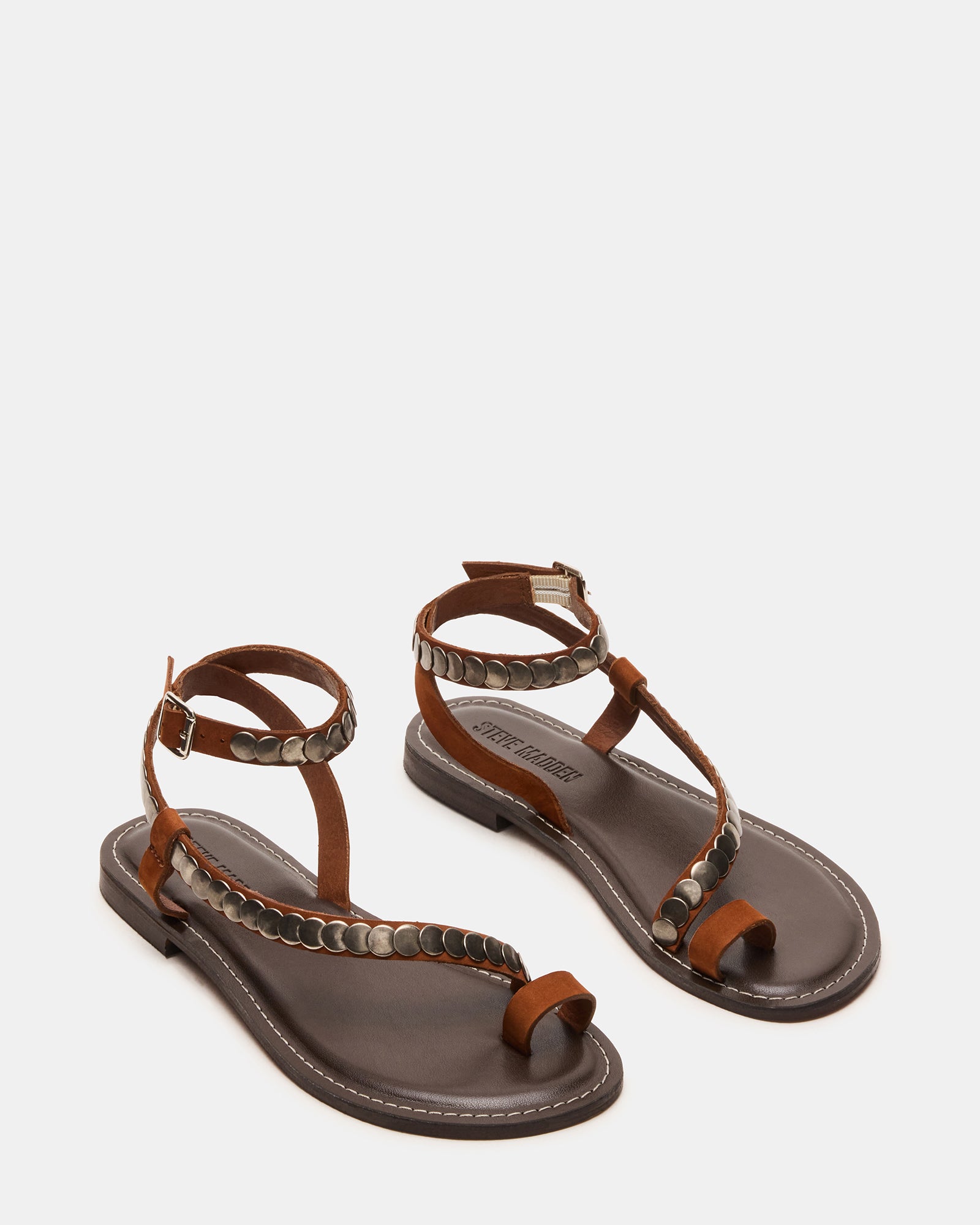 Side angle showing gold strappy sandals paired with flowy beachwear