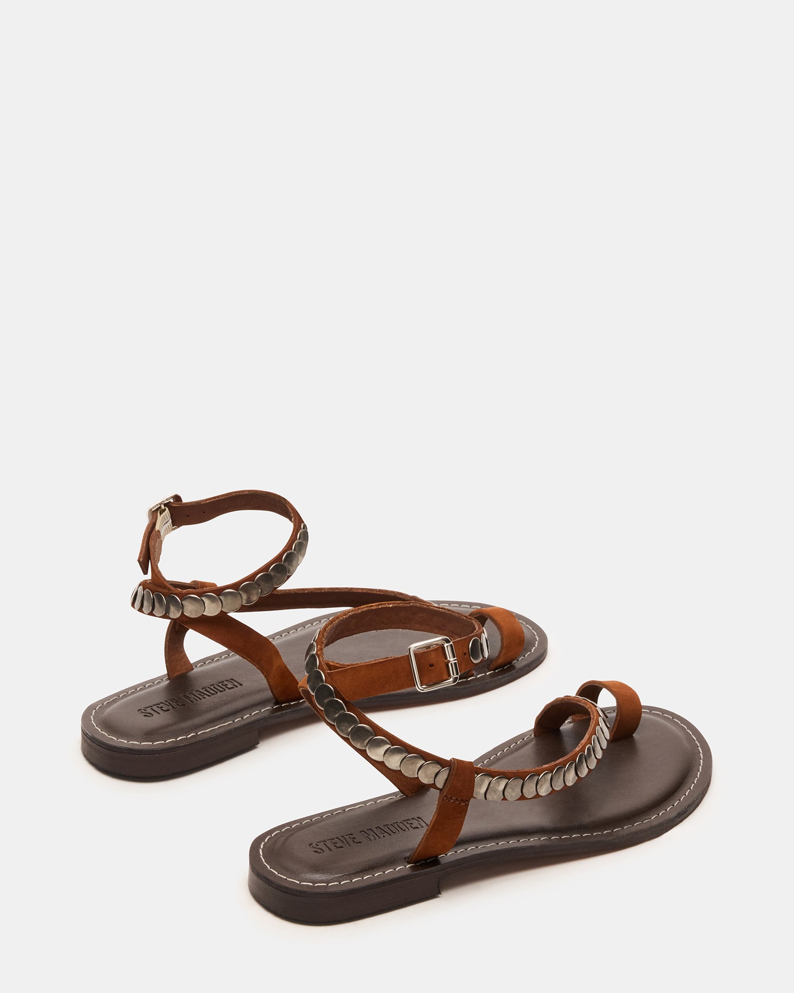 Side angle showing gold strappy sandals paired with flowy beachwear