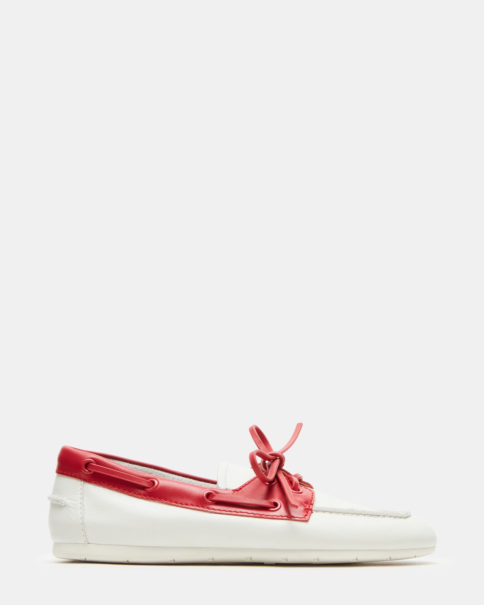 Front view of red leather loafers on a wooden surface.