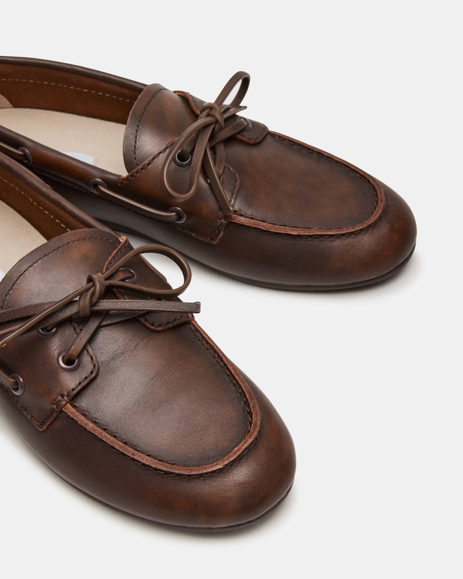 SAG brown leather loafers viewed from the side, highlighting the sleek profile.