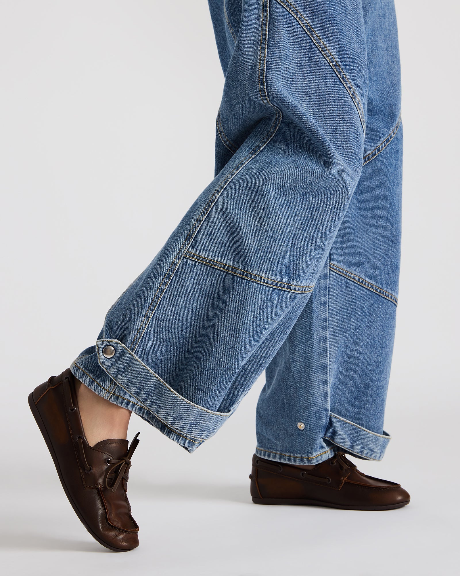 Close-up of the loafers highlighting the leather texture and heel.