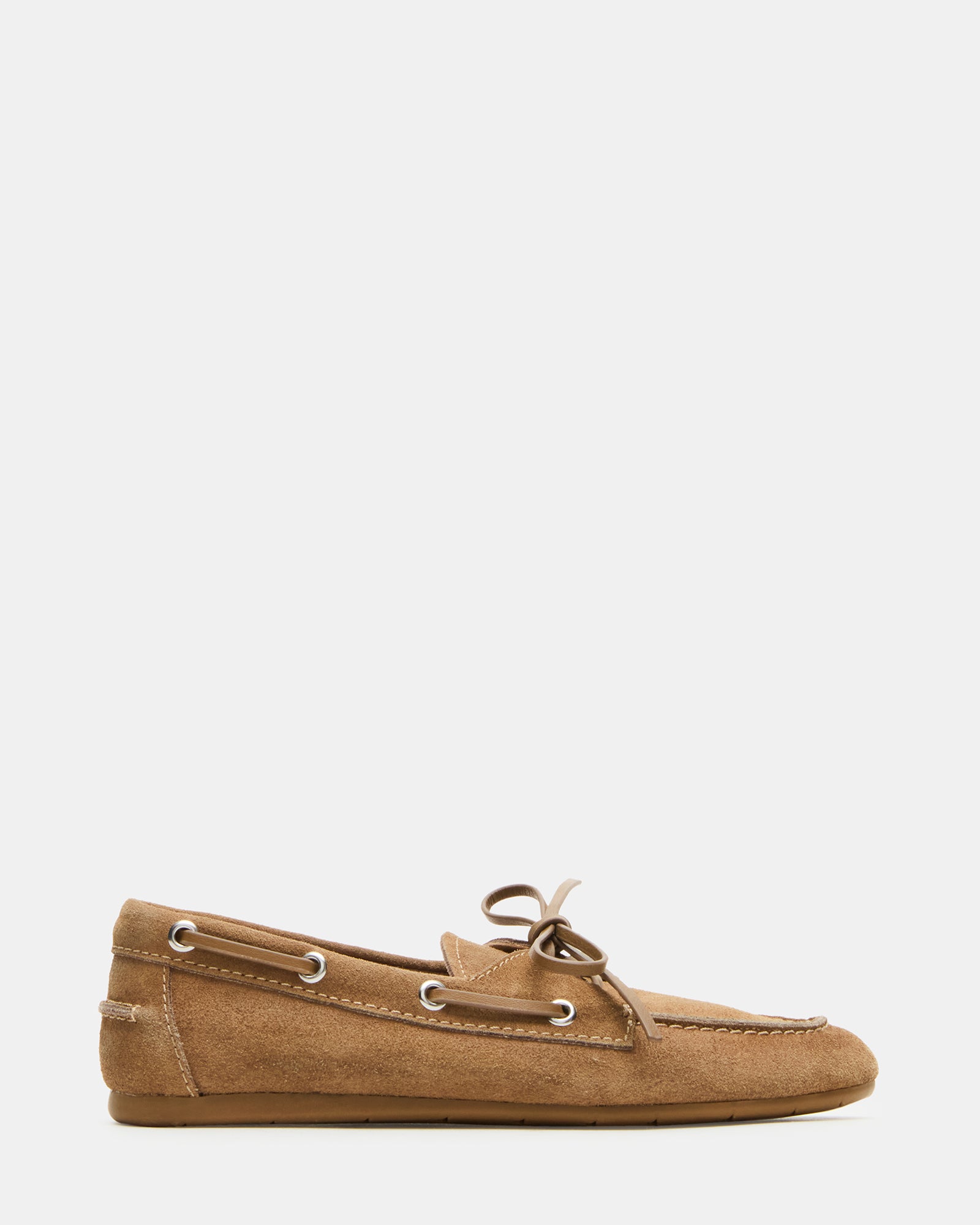 Side view of taupe suede loafers on hardwood floor