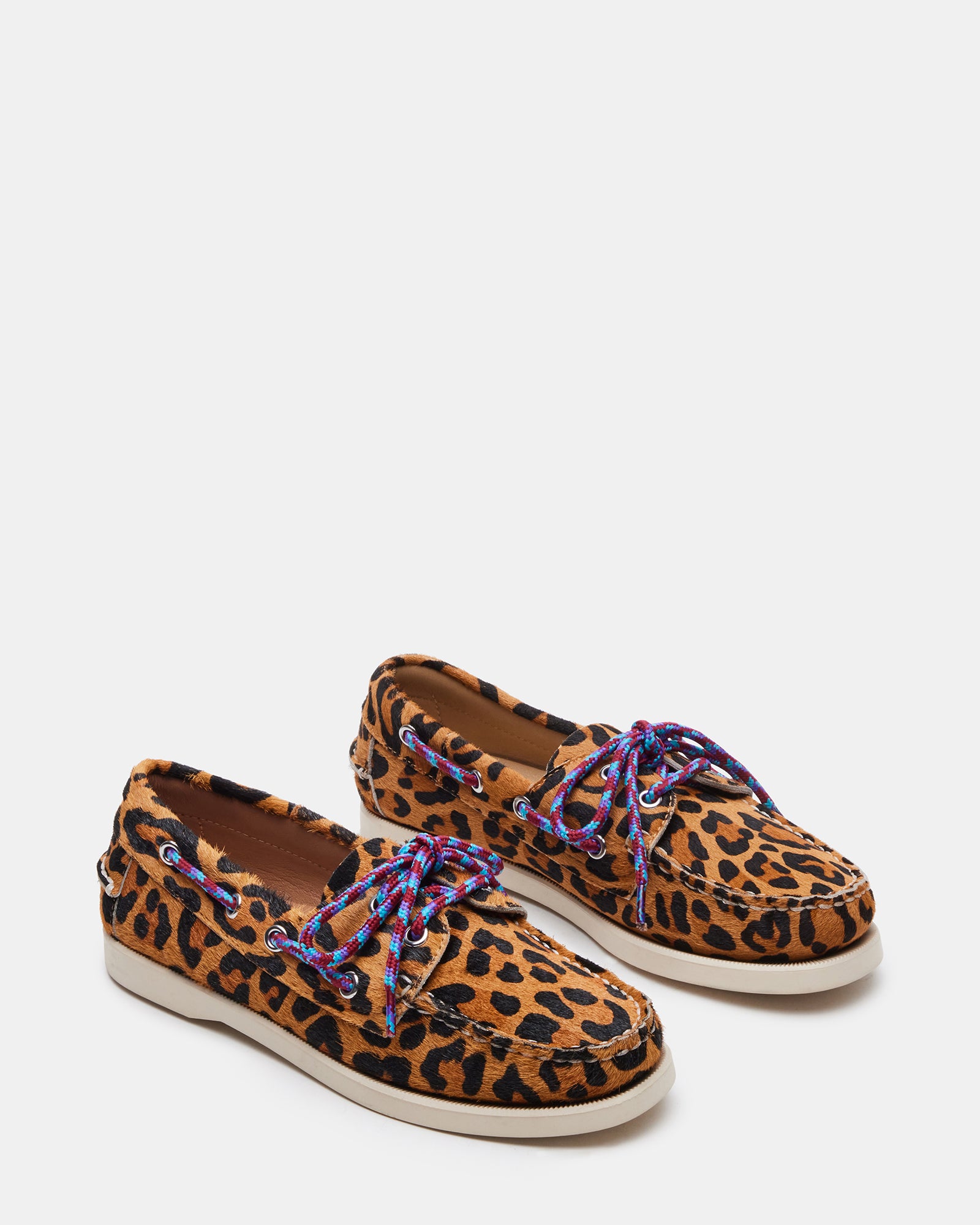 Side view of the loafer against beach wood backdrop, emphasizing versatility
