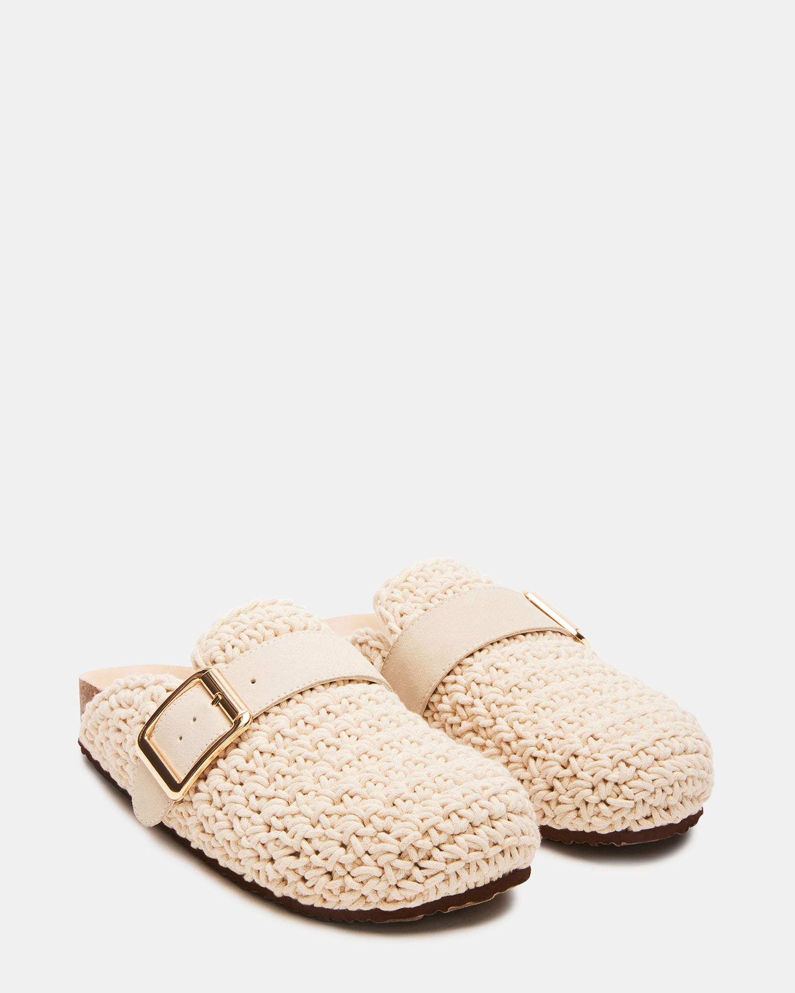 Model wearing Timeless Knit Cream Clogs in a casual outdoor setting.