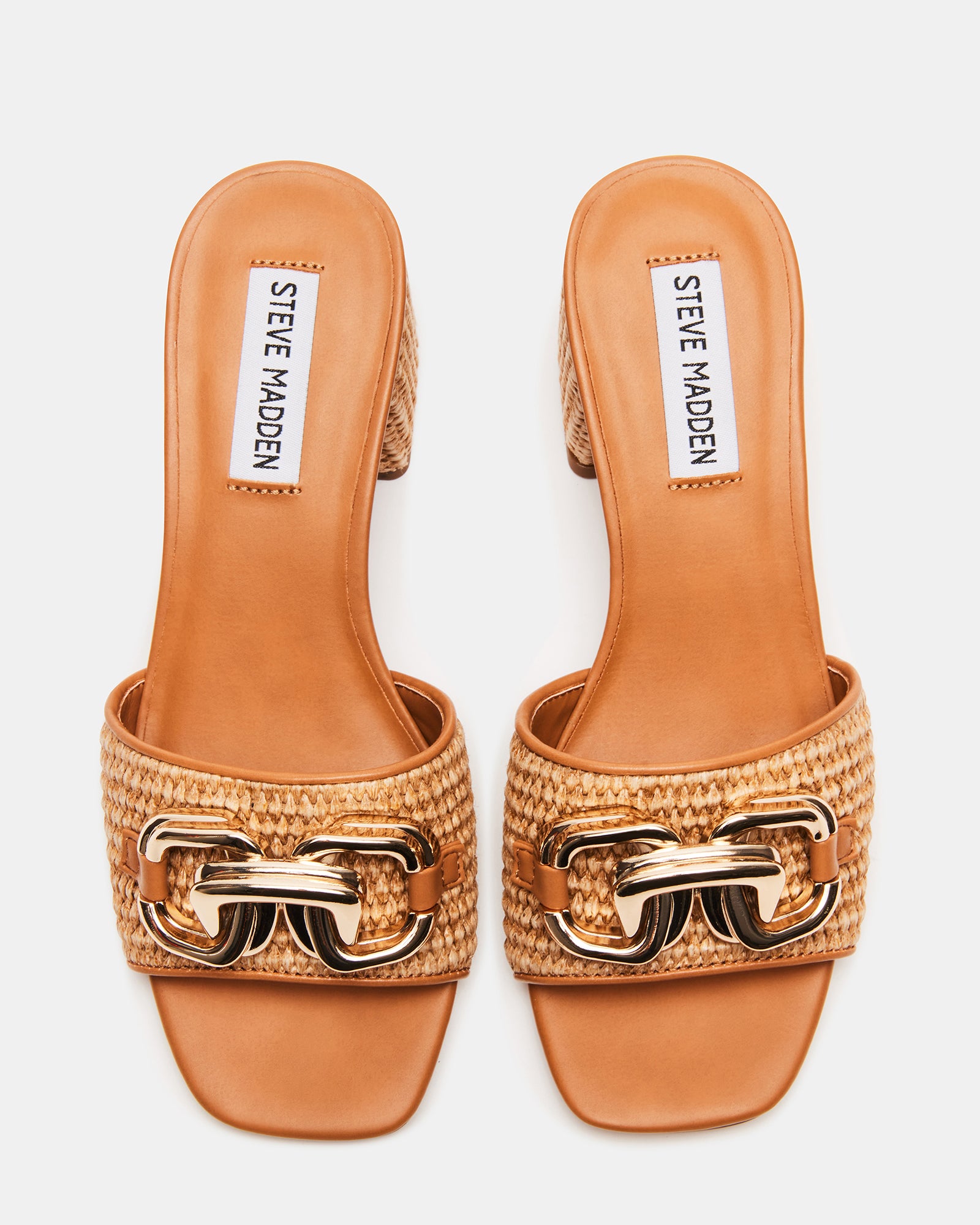 Side profile of gold block heel sandals showing raffia texture and chain detail