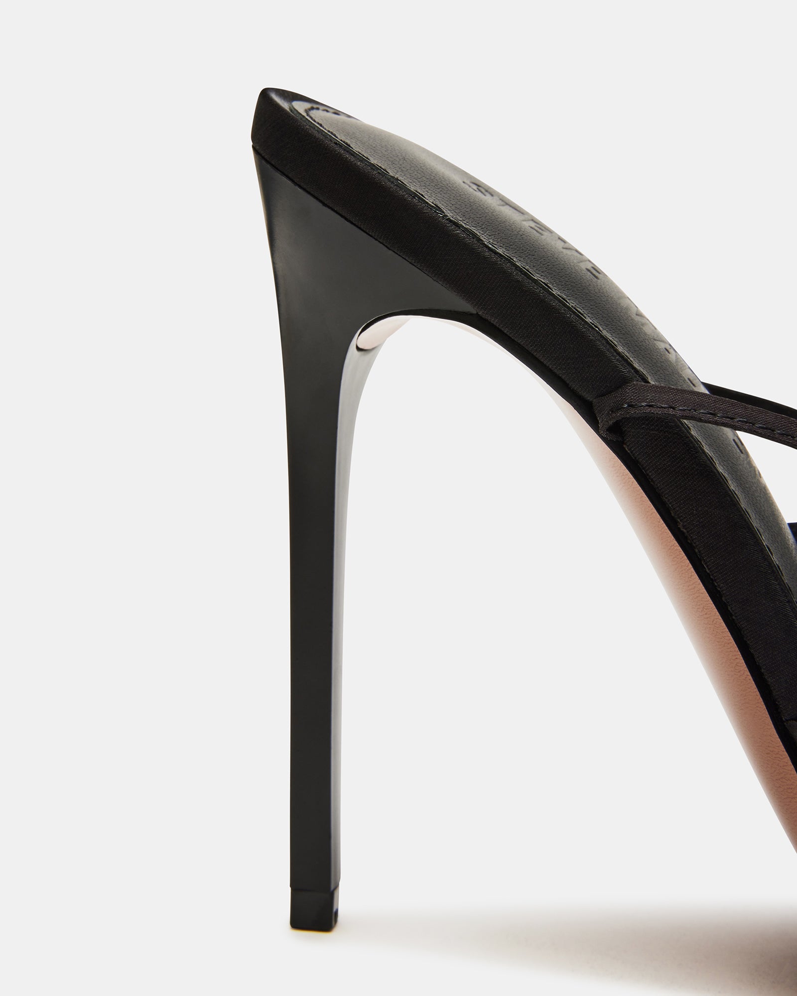 Close-up of lace-up stiletto heels highlighting black colour and pointed toe