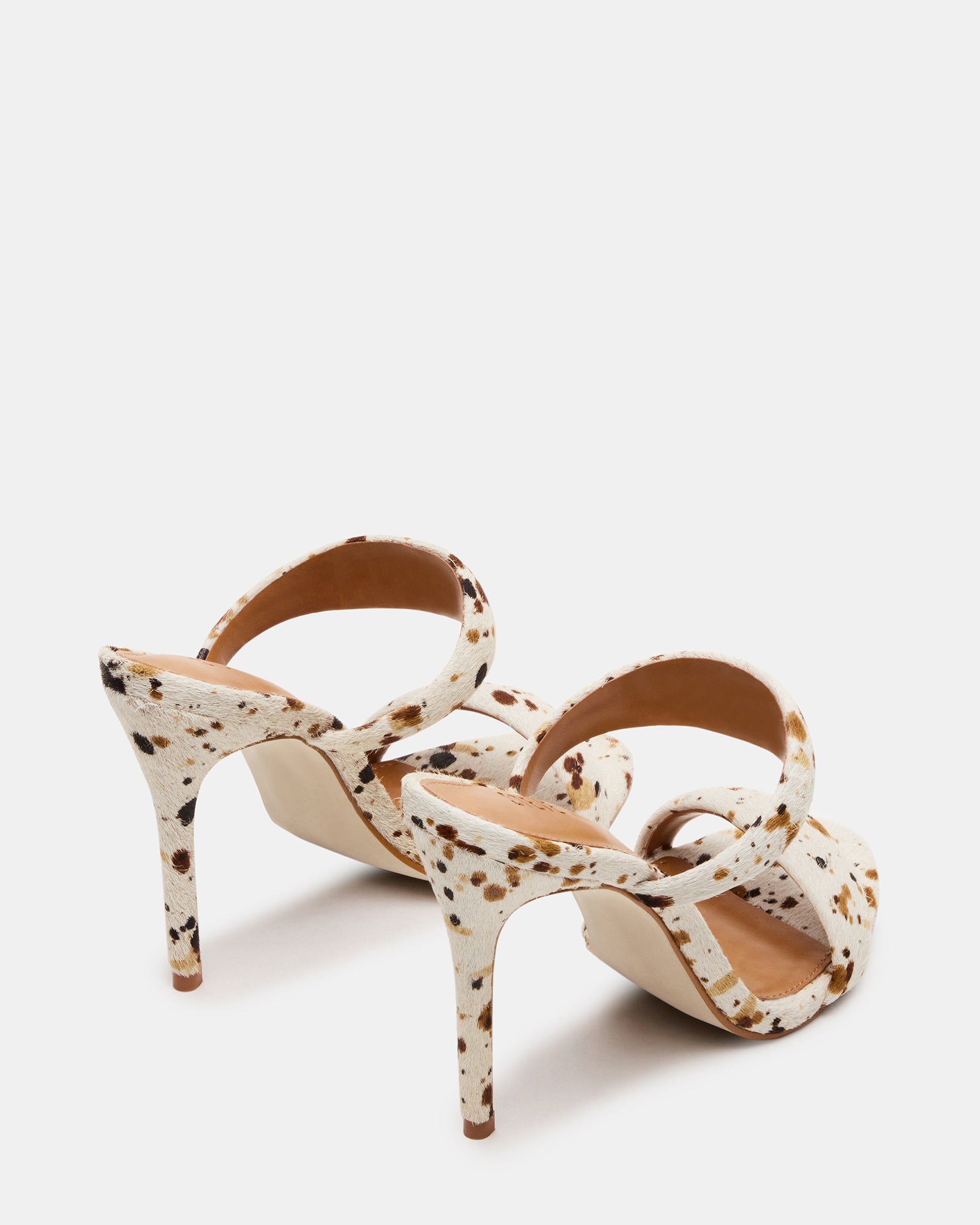Close-up of the leather texture and cow print pattern on Saturn heels