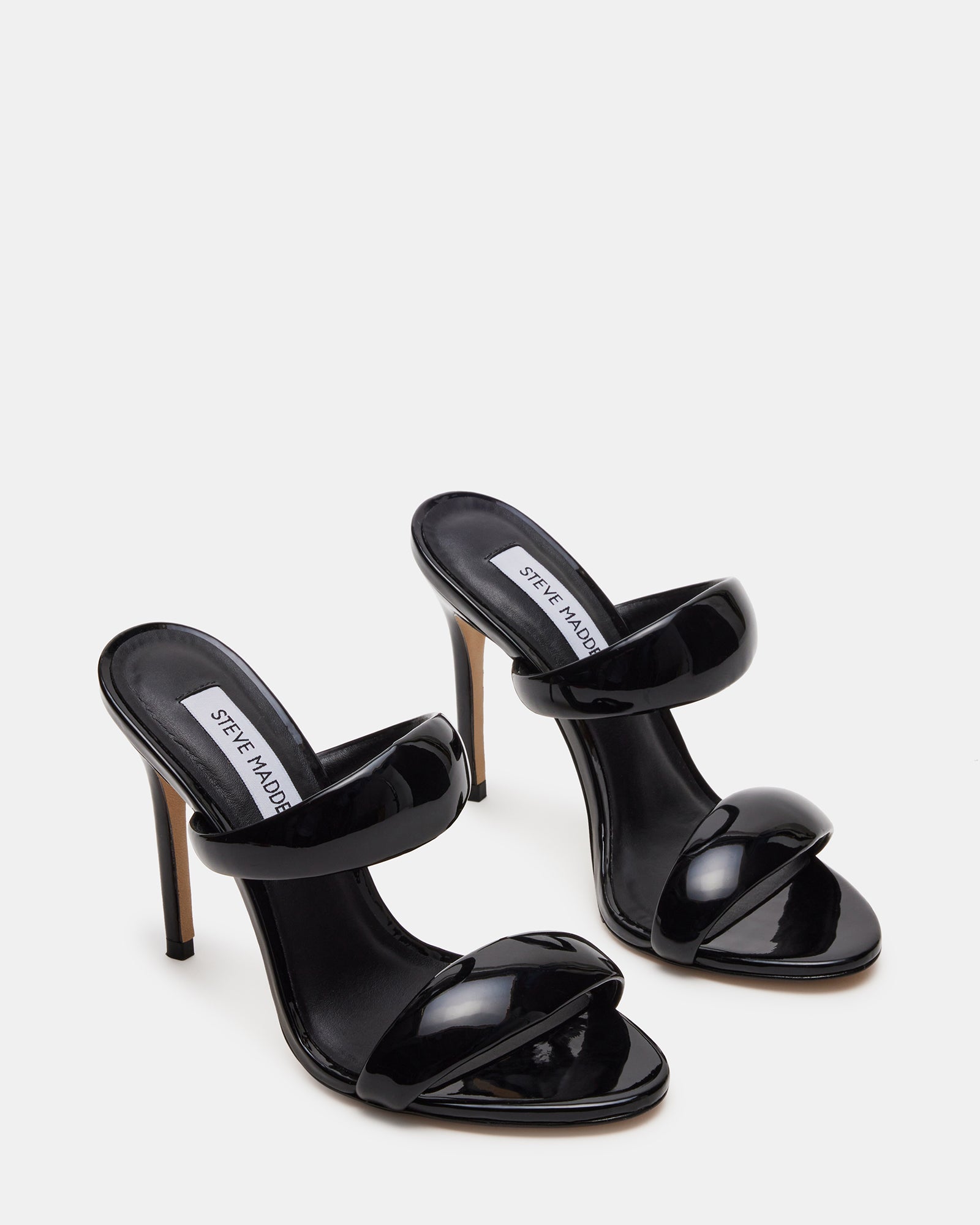 Woman wearing SATURN black mule shoes in a city setting