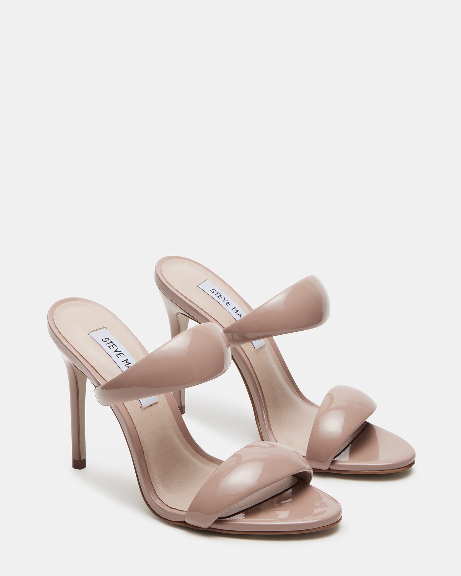 Model wearing Saturn Blush patent mule heels, perfect for a night out.