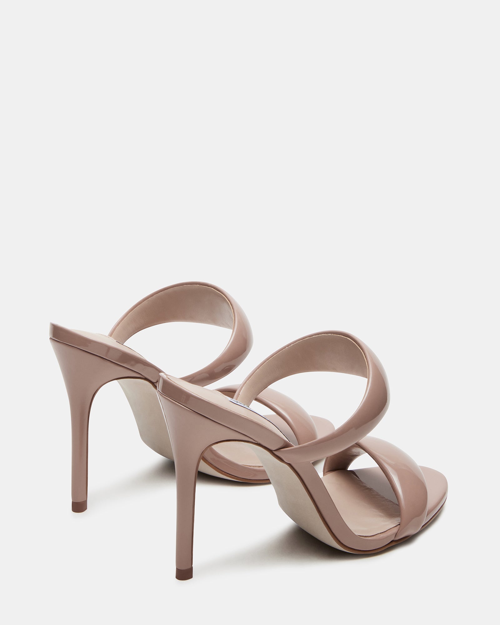 Model wearing Saturn Blush patent mule heels, perfect for a night out.