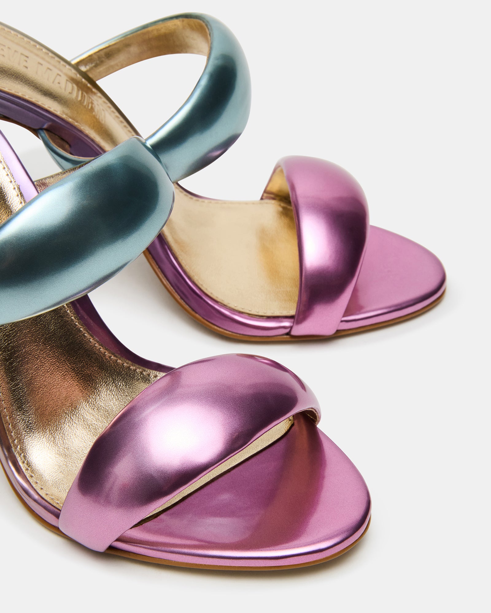 Overhead look at kitten heel mules shoes with tubular straps and modern silhouette