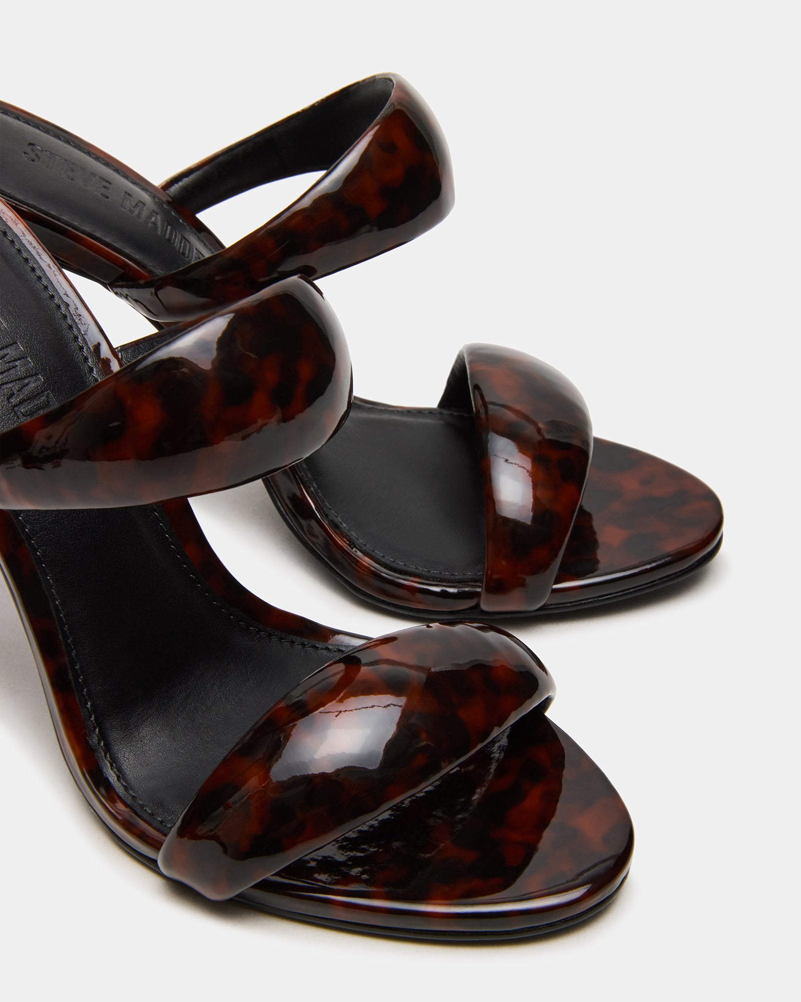 Close-up of synthetic upper and sole of Saturn Tortoise fashion heels