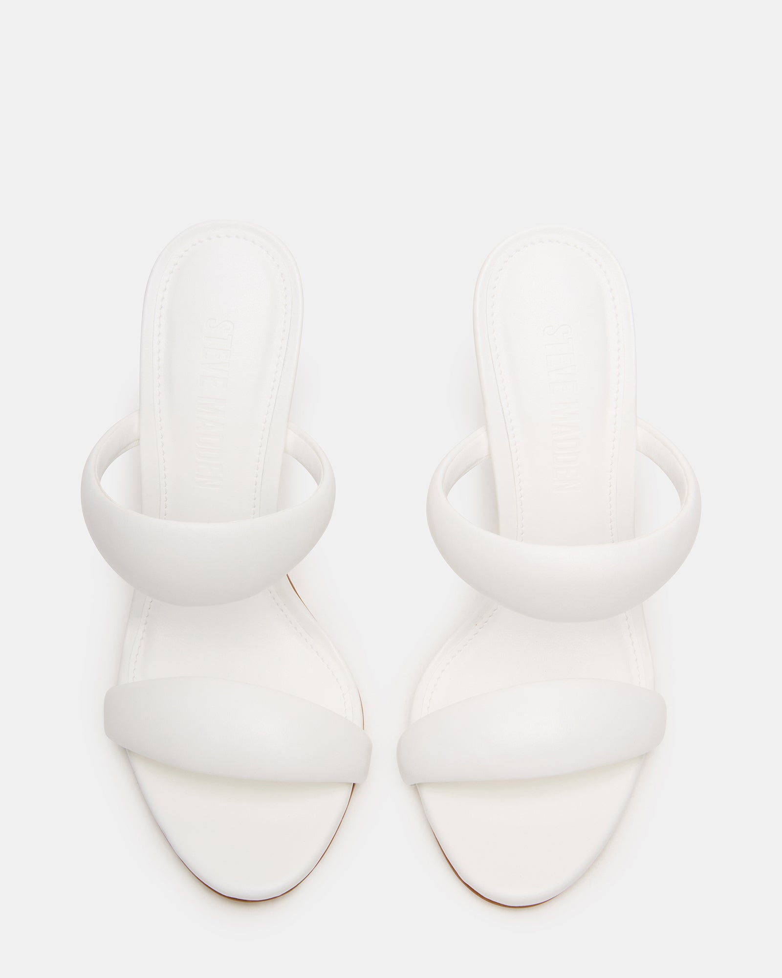 Close-up of stiletto heel on Luxe Saturn White Mule Heels.