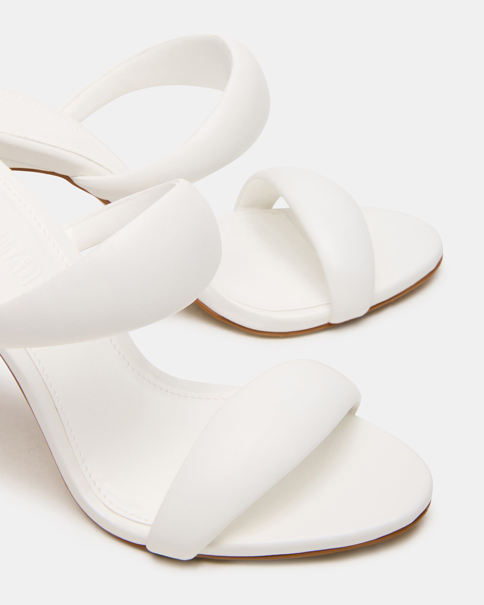 Elegant white mule heels with double strap for a chic look.