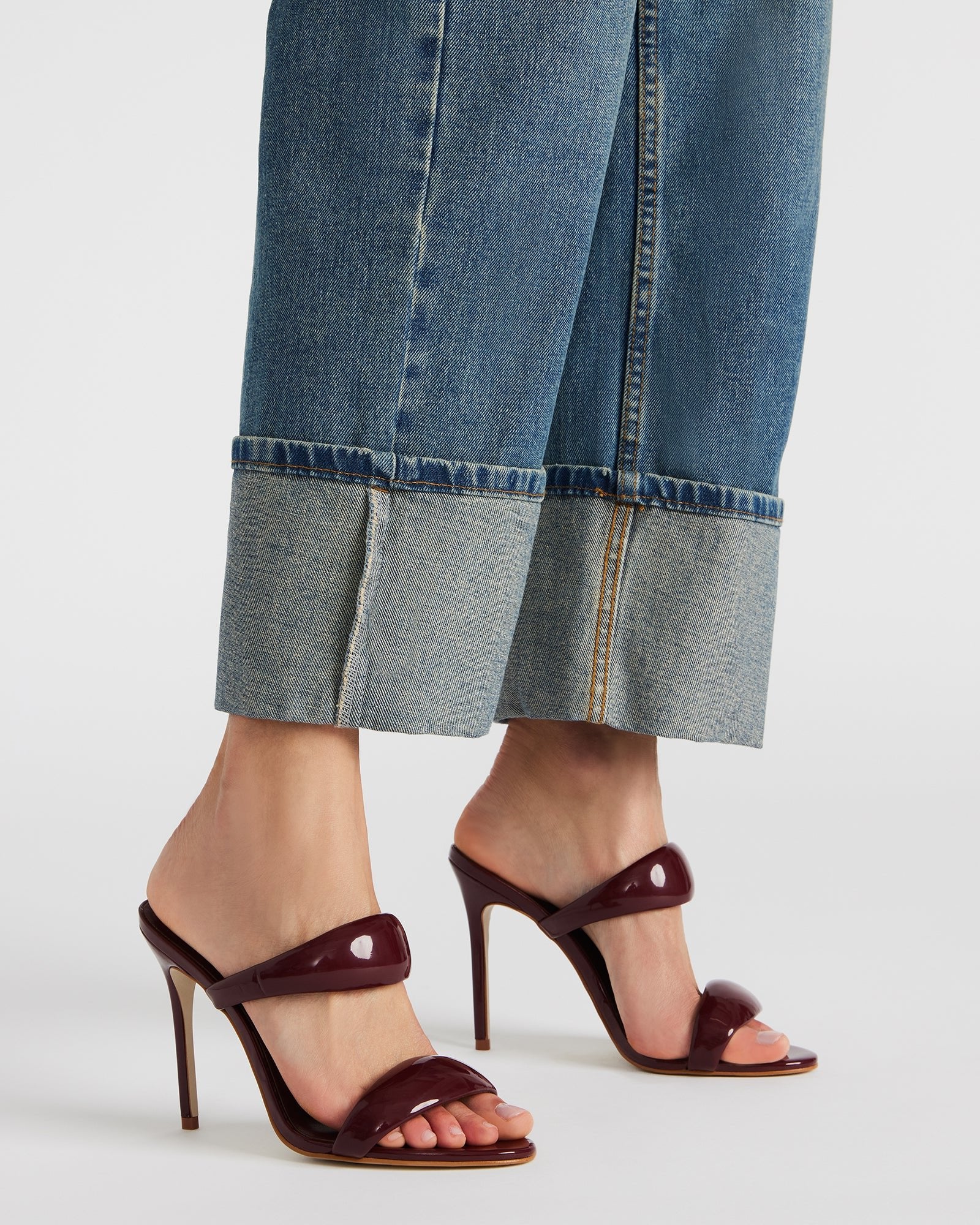 Front view of fashionable Saturn Wine Patent mules showing stylish design