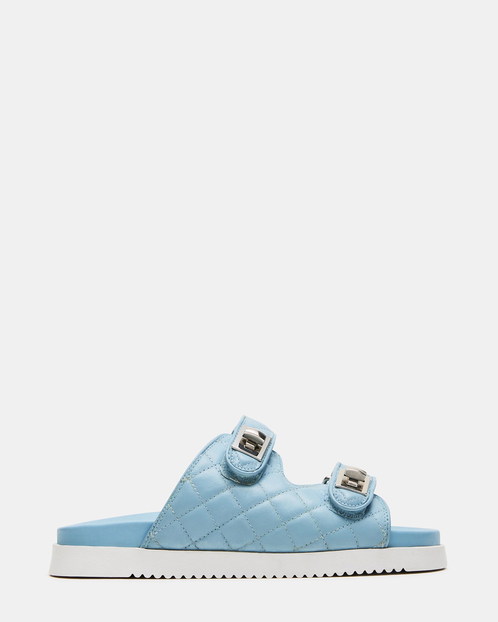 Top view of quilted sandals slides shoes womens in natural light