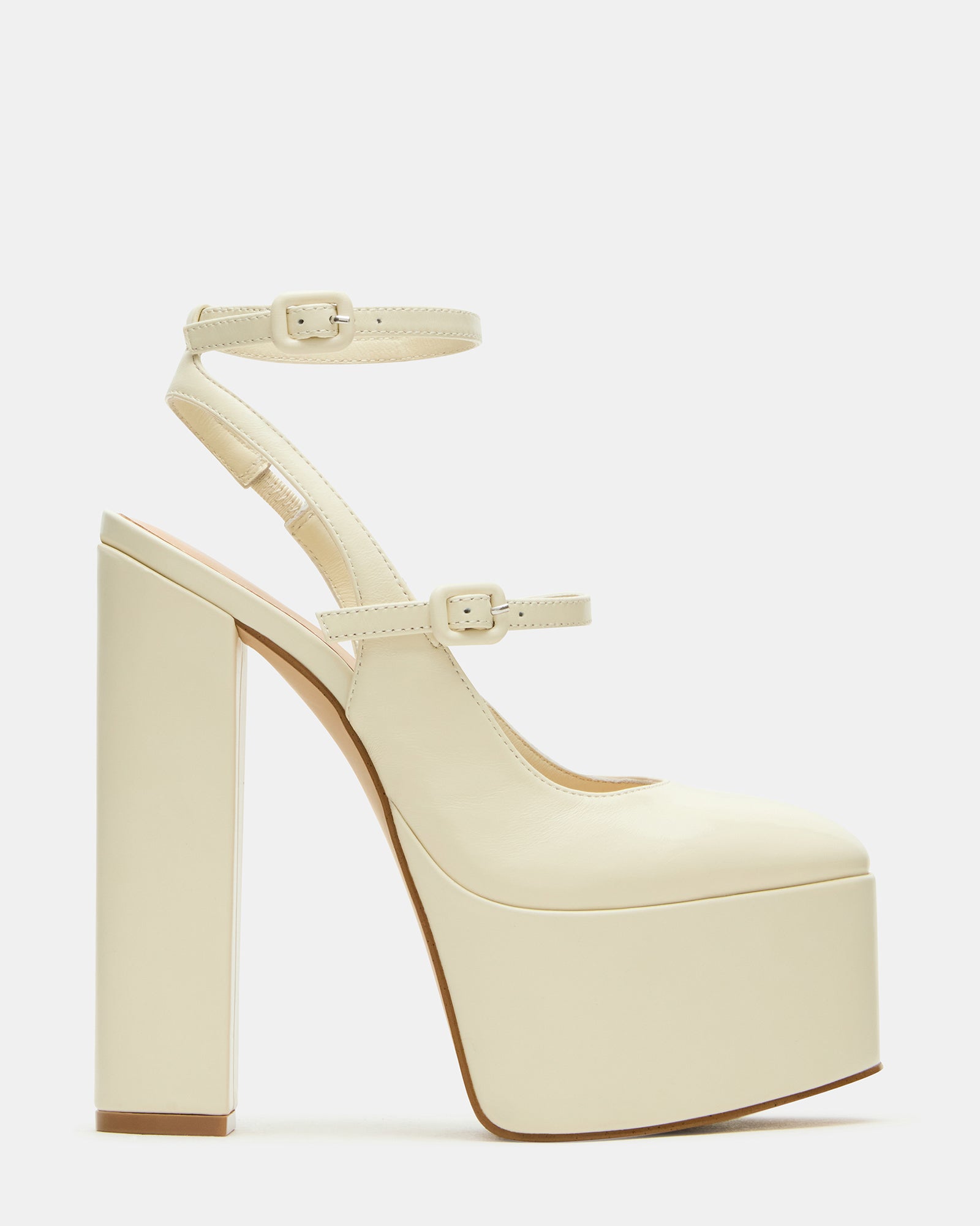 Side view of strappy bone leather platform heels showcasing the ankle strap.