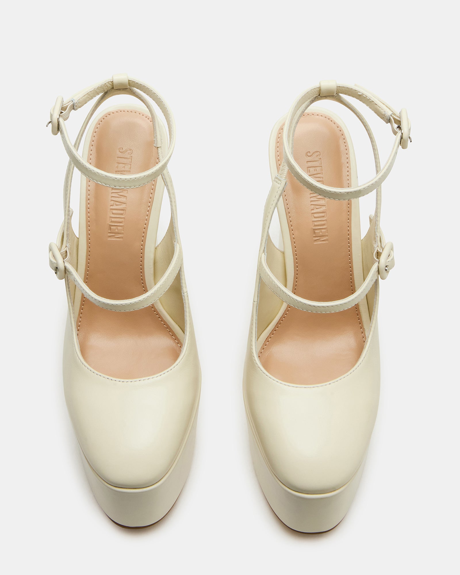 Side view of strappy bone leather platform heels showcasing the ankle strap.