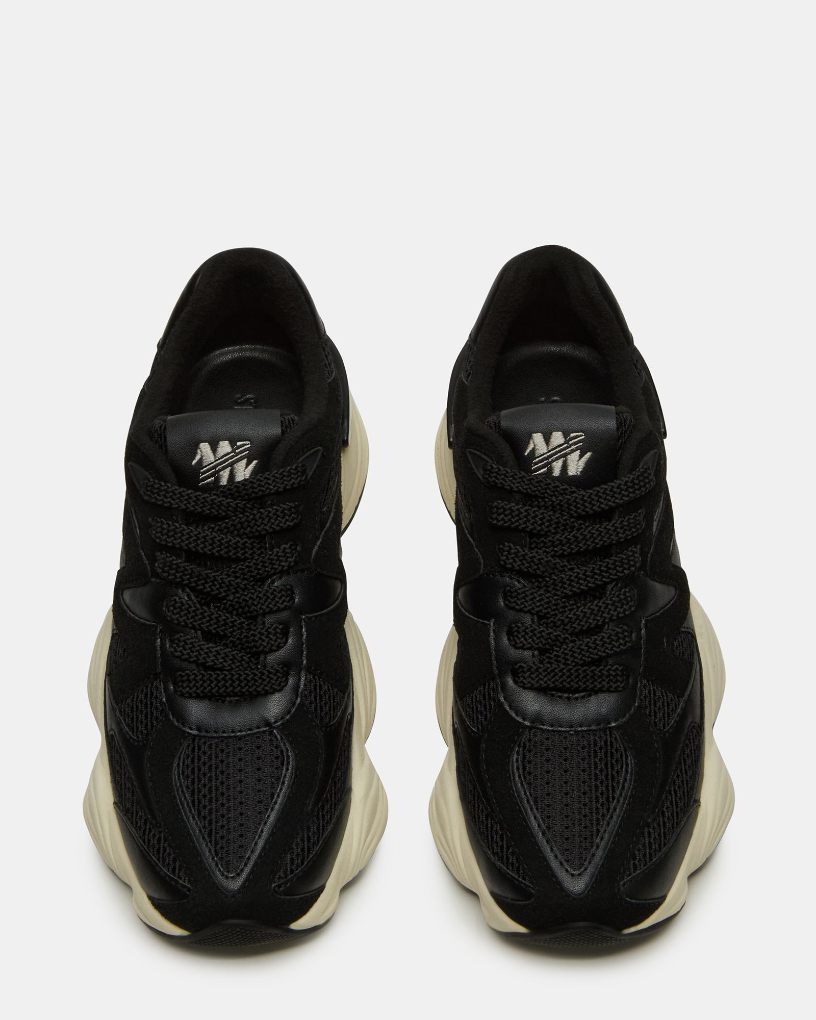 Close-up of textured faux suede and textile blend on SEBI bottega sneakers in classic black.