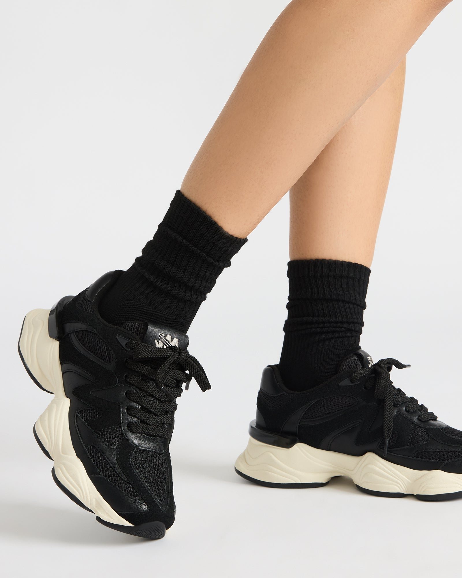 Close-up of textured faux suede and textile blend on SEBI bottega sneakers in classic black.