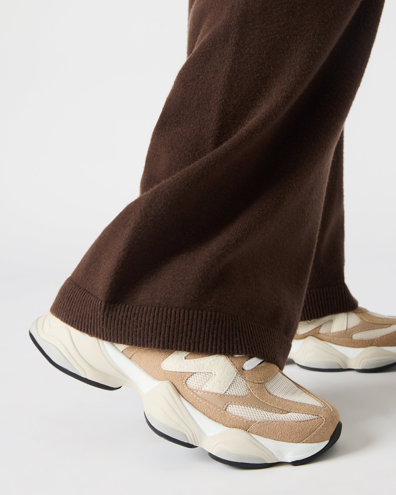 Close-up of the lace-up detail on taupe womens sneakers, highlighting quality materials.