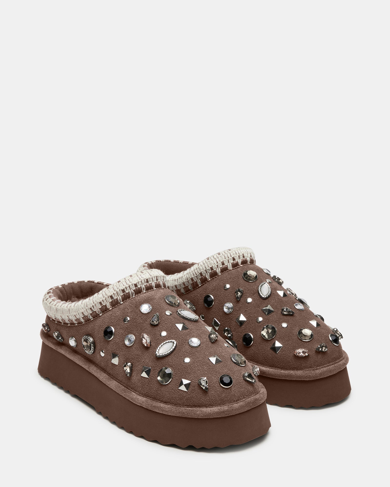 Lifestyle shot of mens mule slippers styled with loungewear in indoor setting