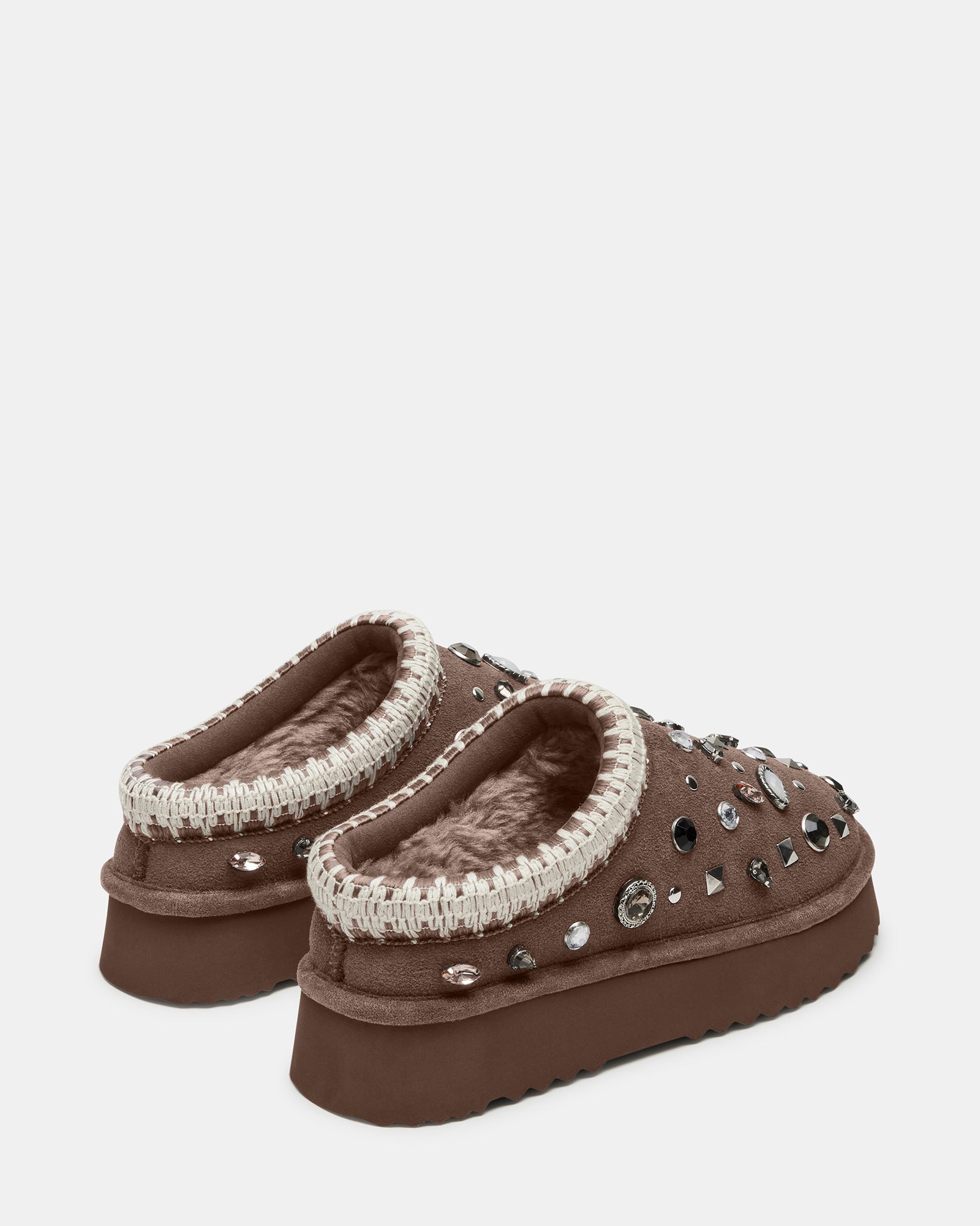 Lifestyle shot of mens mule slippers styled with loungewear in indoor setting