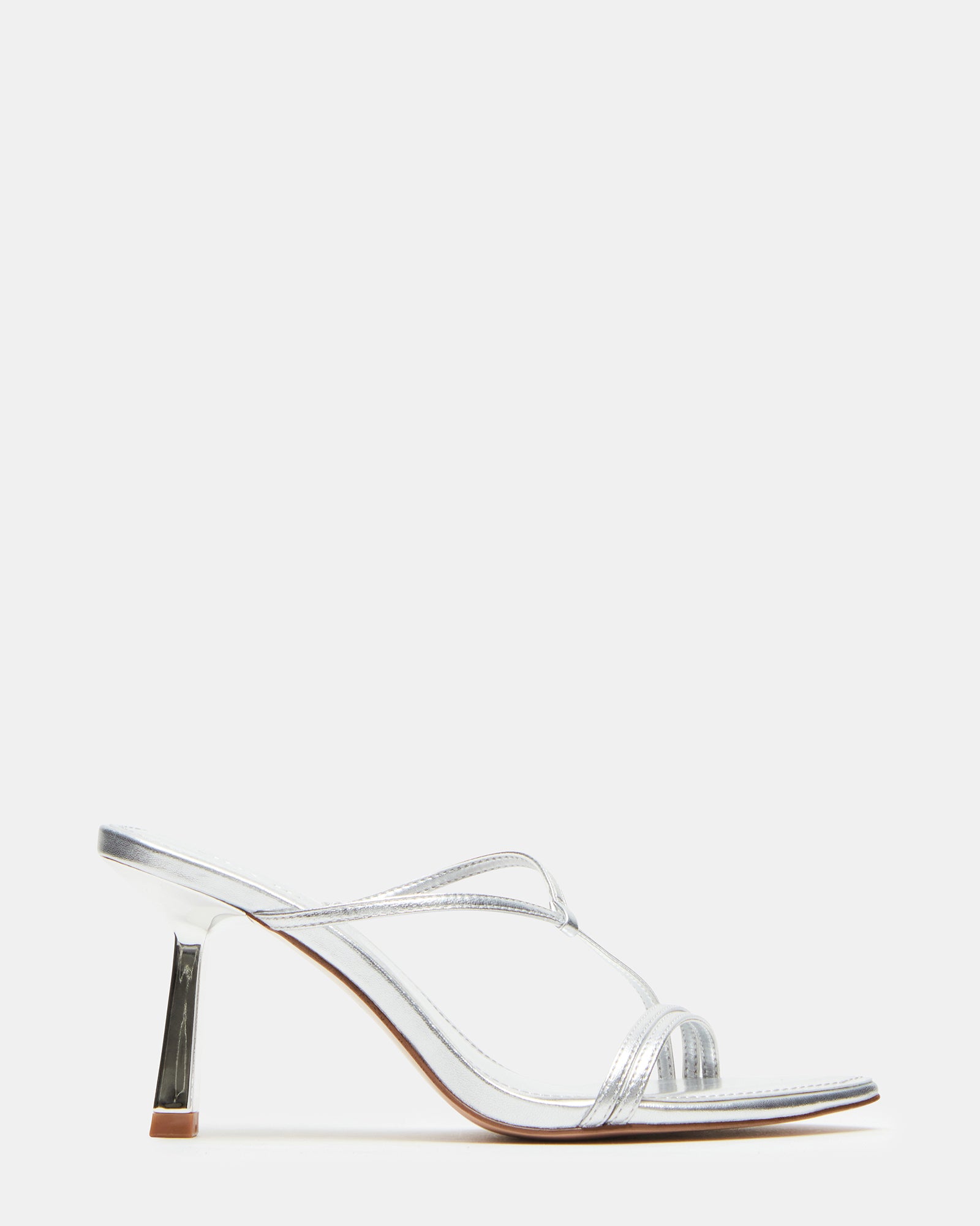 Silver strappy mule sandals worn with tailored trousers