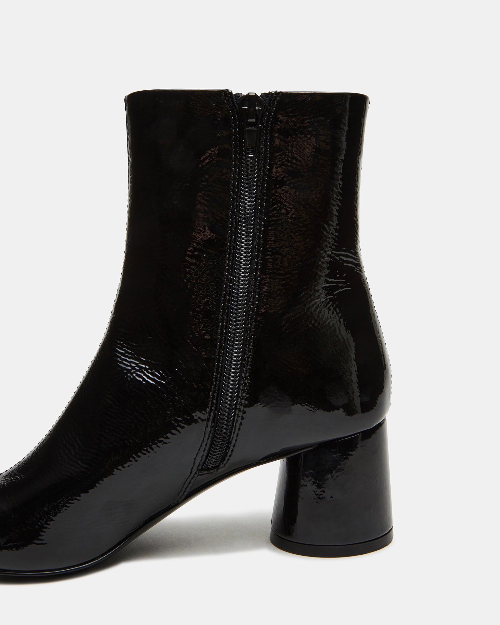 Men boots leather black styled with denim on New Orleans city sidewalk