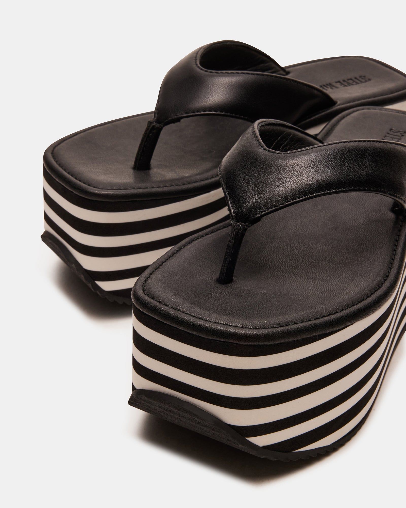 Model showcasing Sevilla black platform sandals styled for a casual day out.