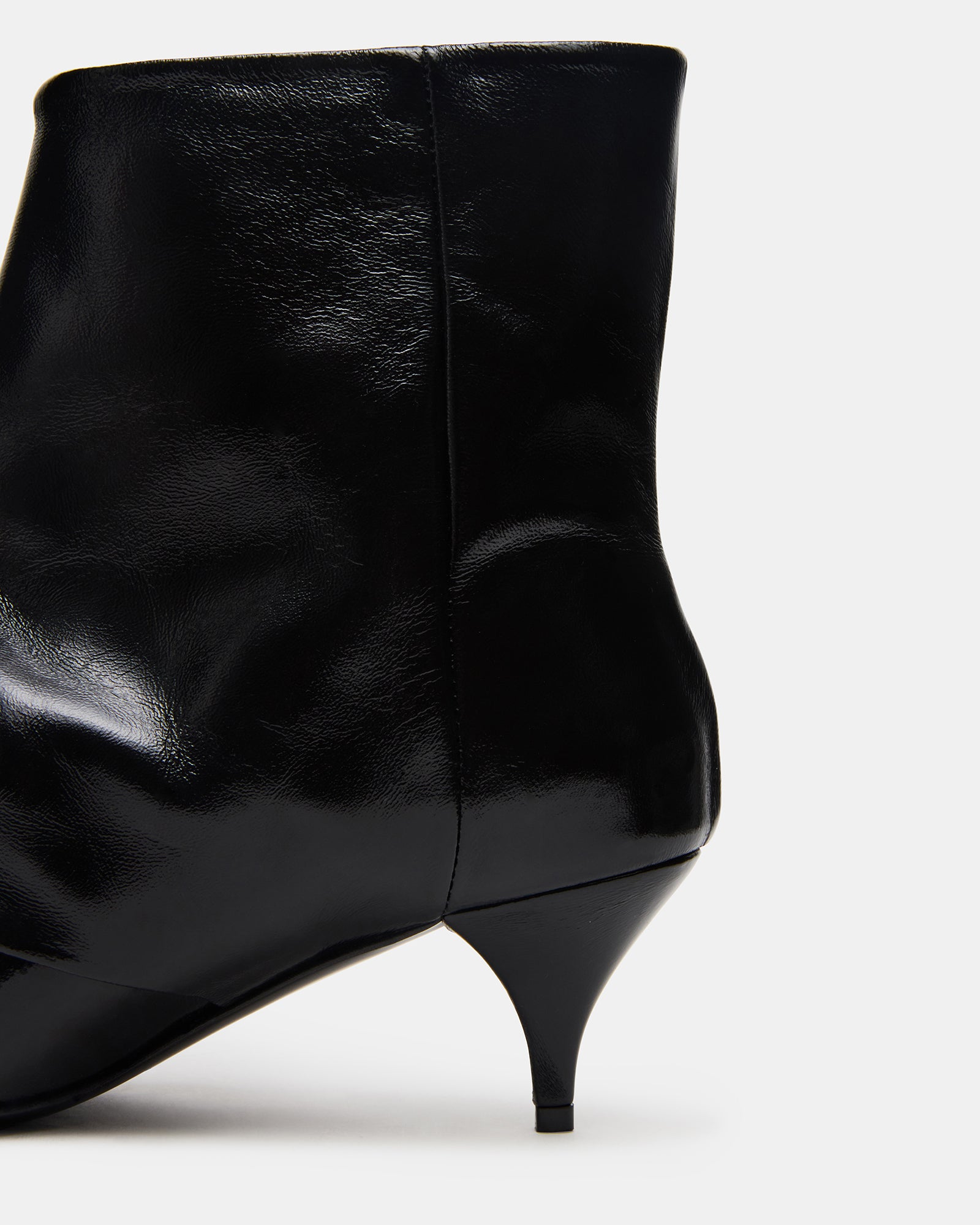 Woman wearing black leather boots with tailored pants for a chic urban look
