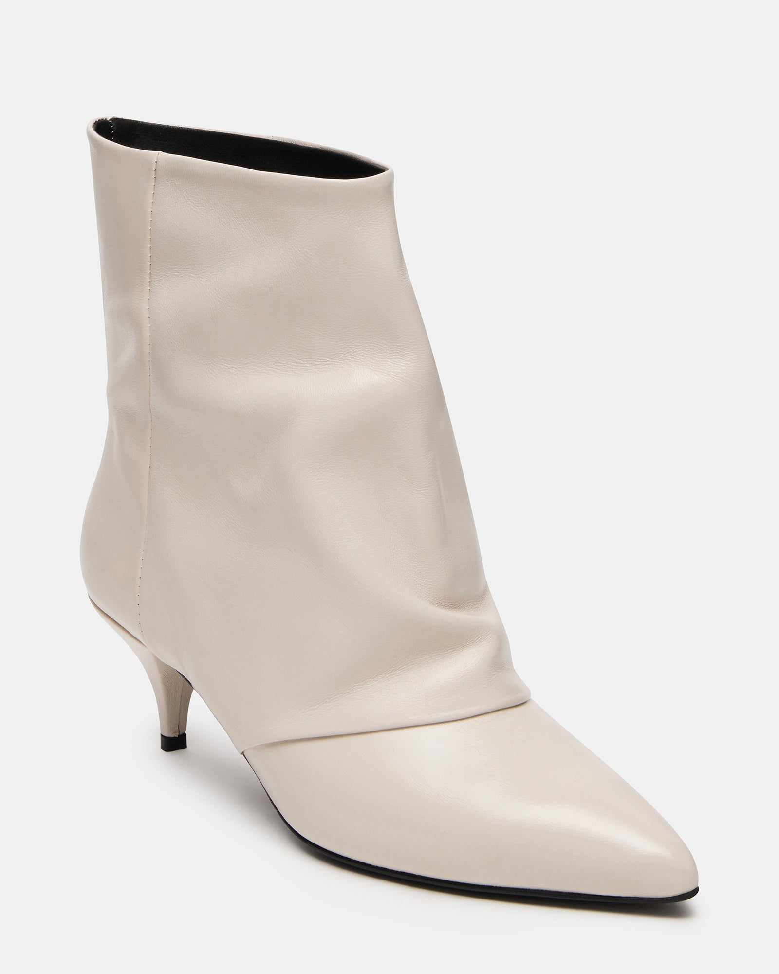 Model wearing white leather ankle boots with a dress for a chic look