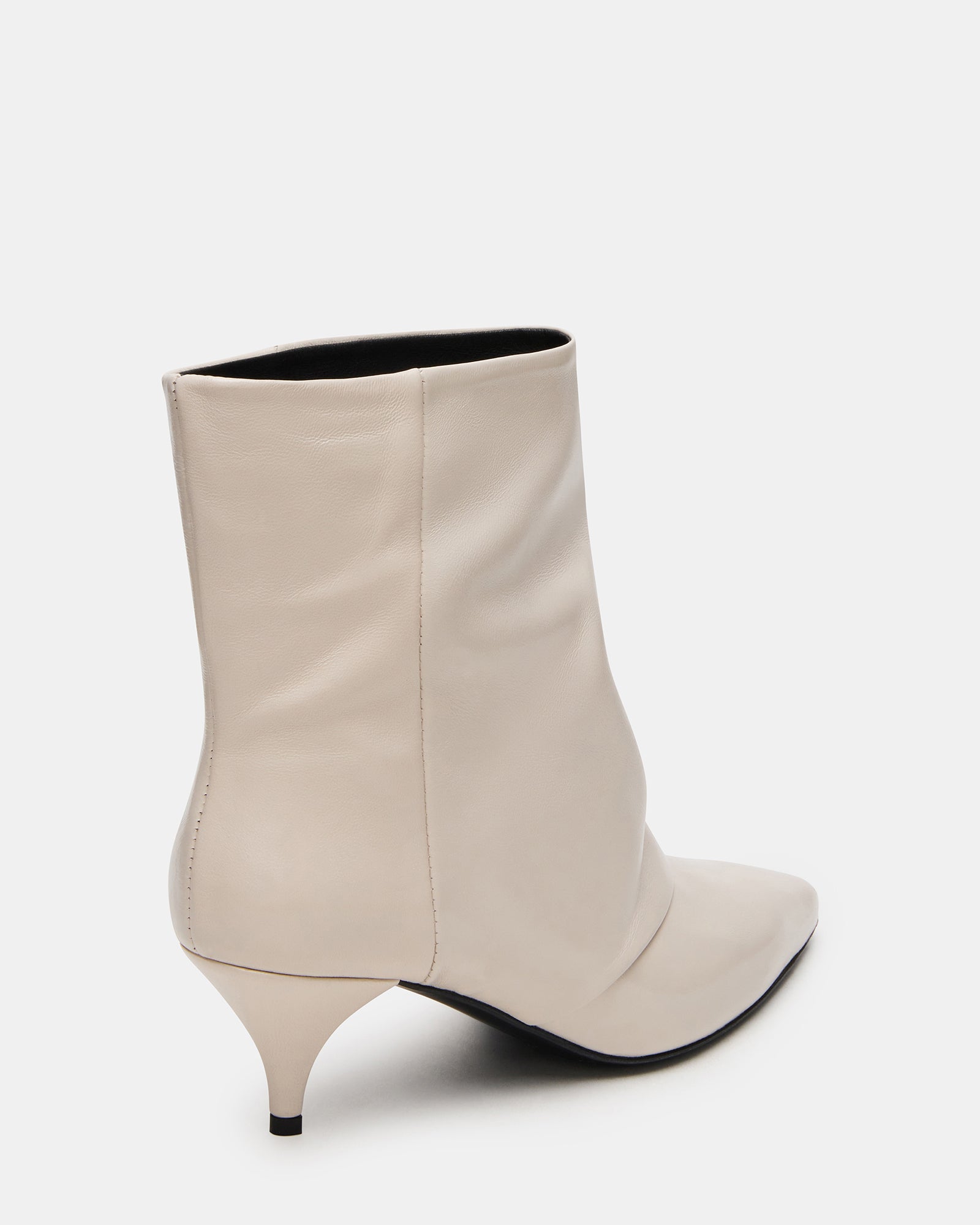 Model wearing white leather ankle boots with a dress for a chic look
