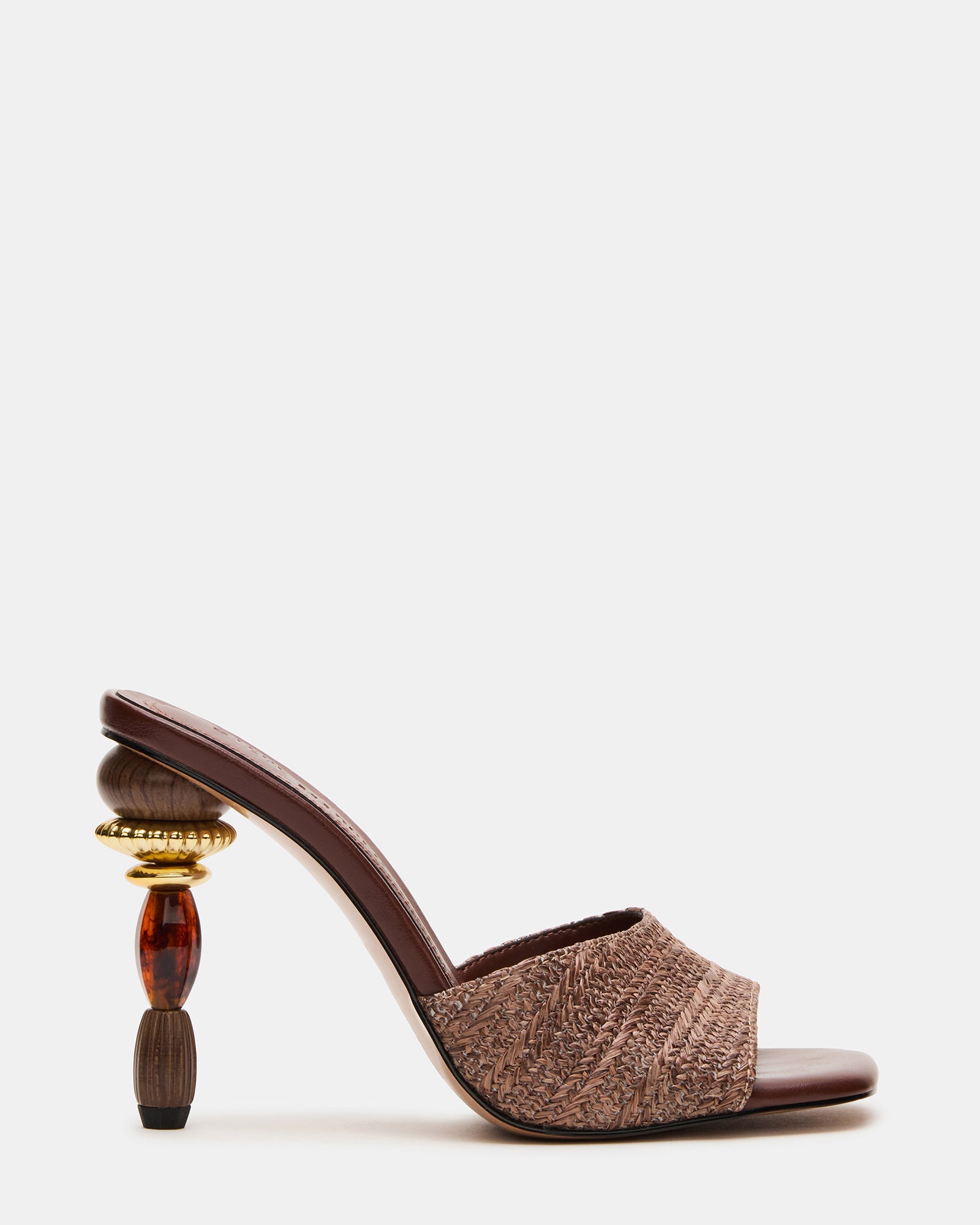 Sia Brown mules heels styled with jeans and a blazer for a chic daytime look.