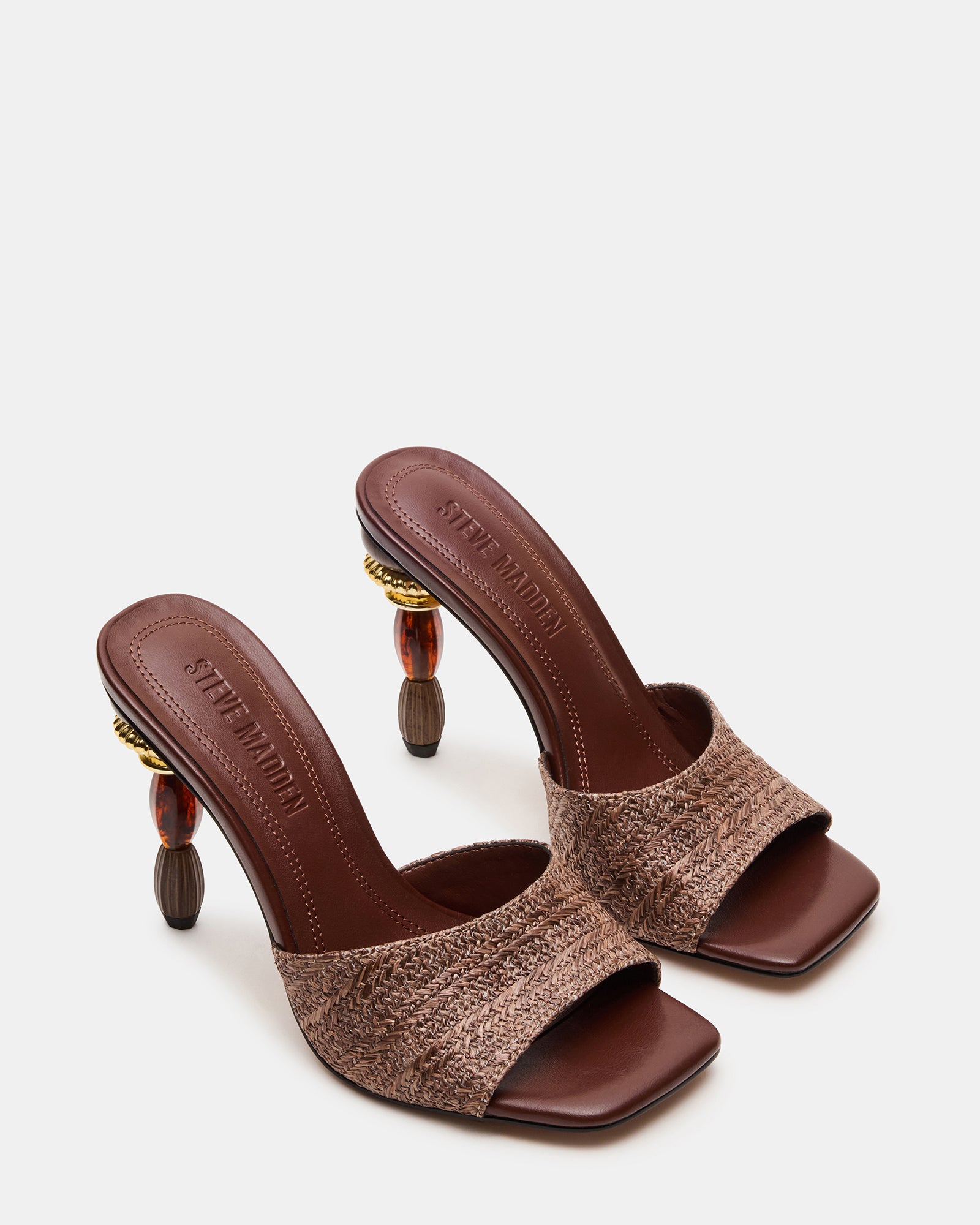 Close-up of the sculptured kitten heel mules showcasing the multi-colored detail.
