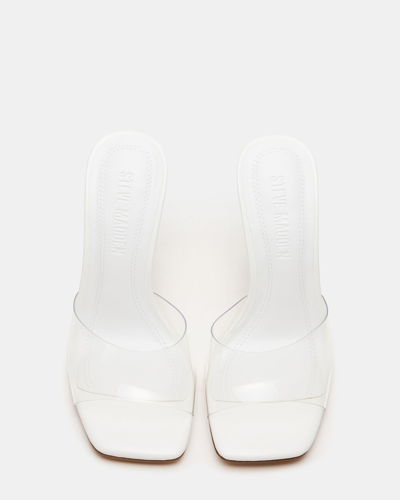 SIA square toe kitten heel mules displayed on a wooden shelf, showcasing the sculptured heel design.