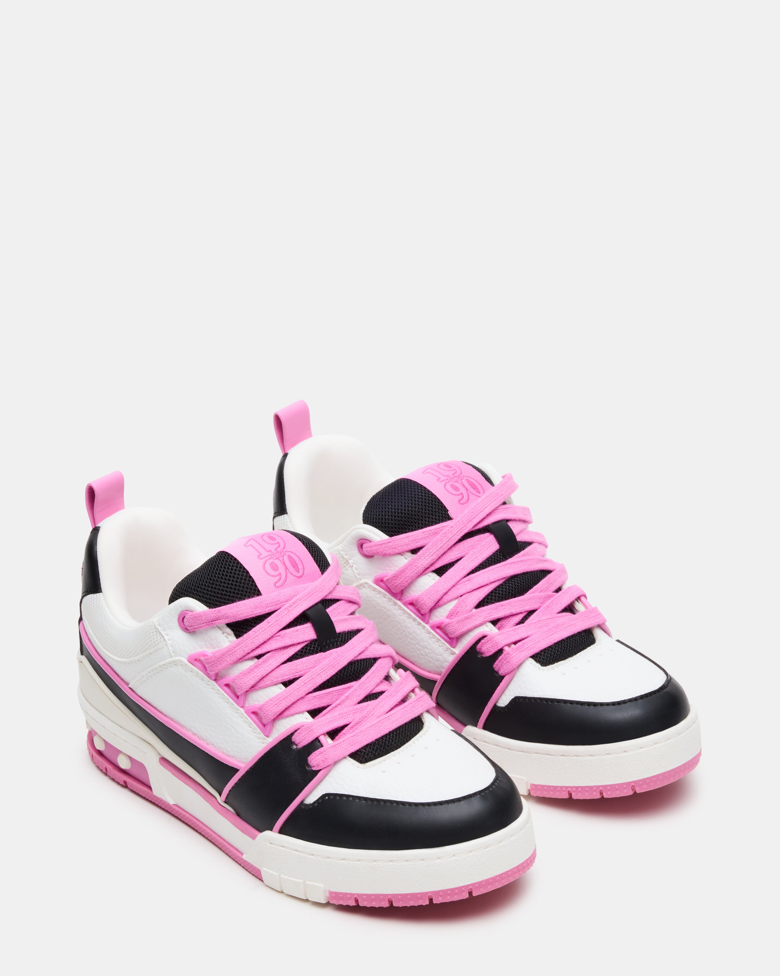SKATER low-top sneakers on feet, showcasing the black and pink design