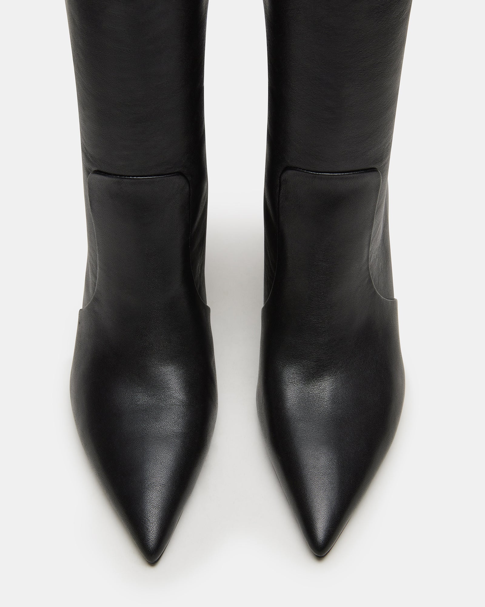 Side view of Skyline black leather knee-high boots showing pointed toe and block heel