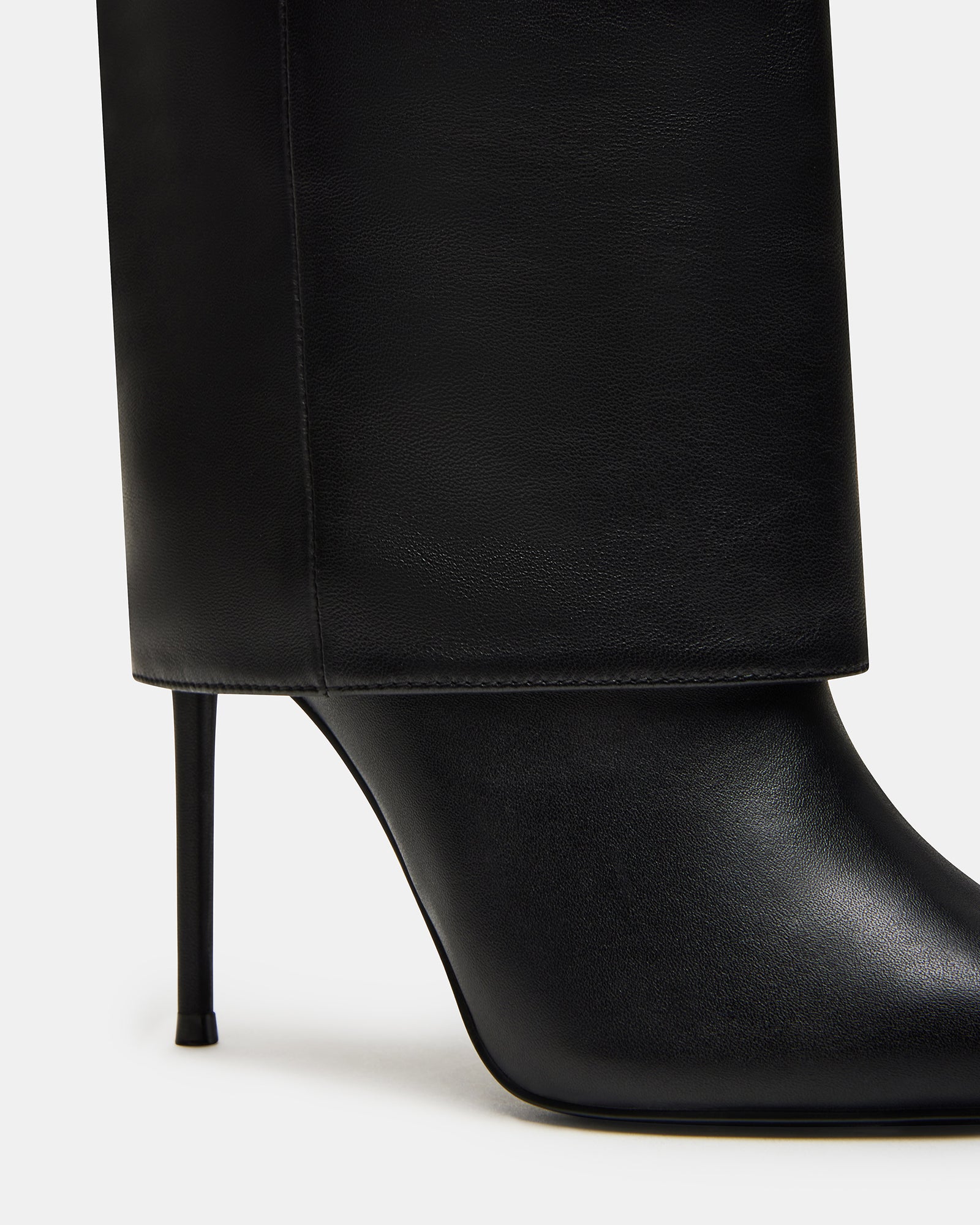 Model wearing black leather wide calf knee high boots with a chic outfit