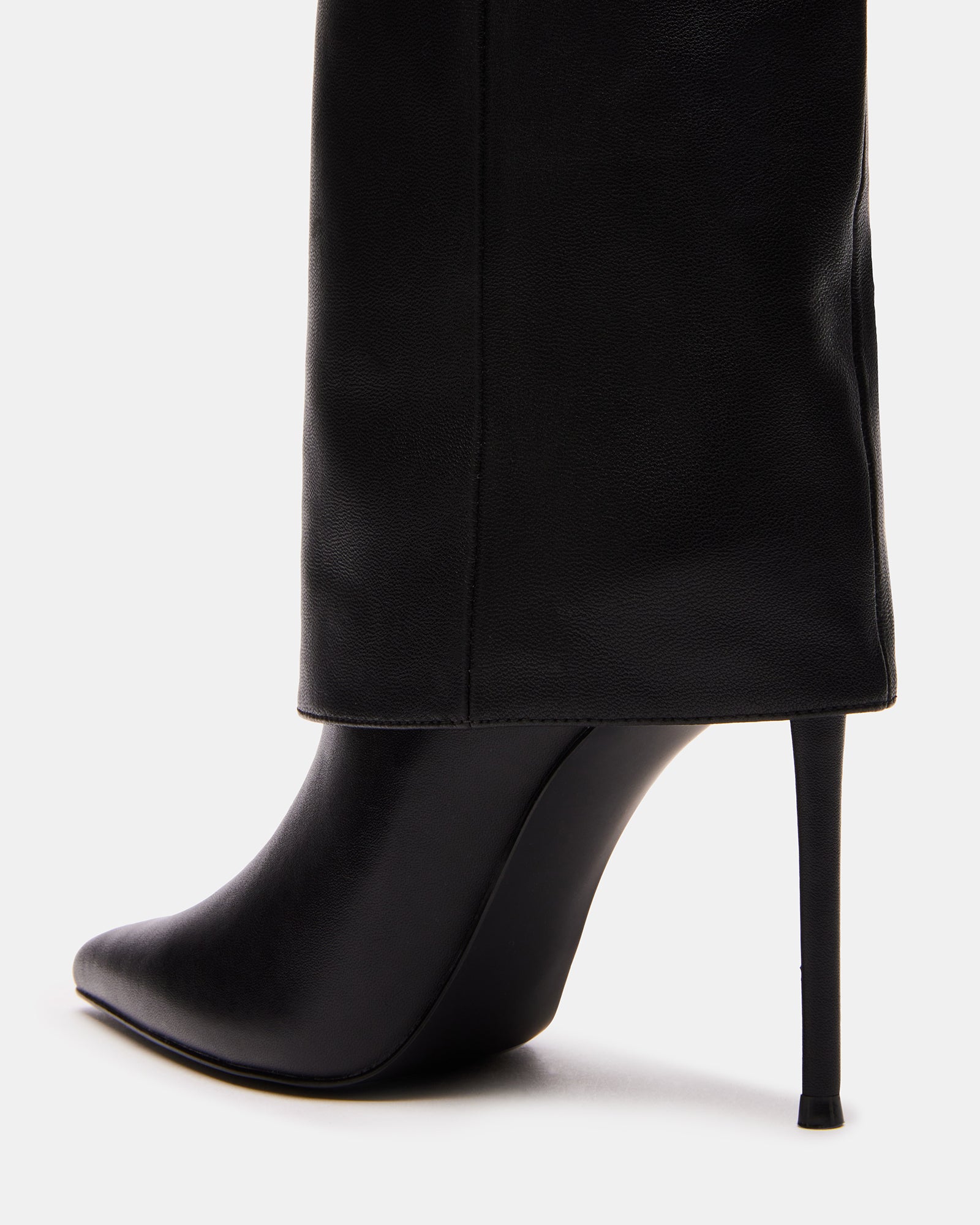 Front view of black stiletto heels styled with denim and oversized coat