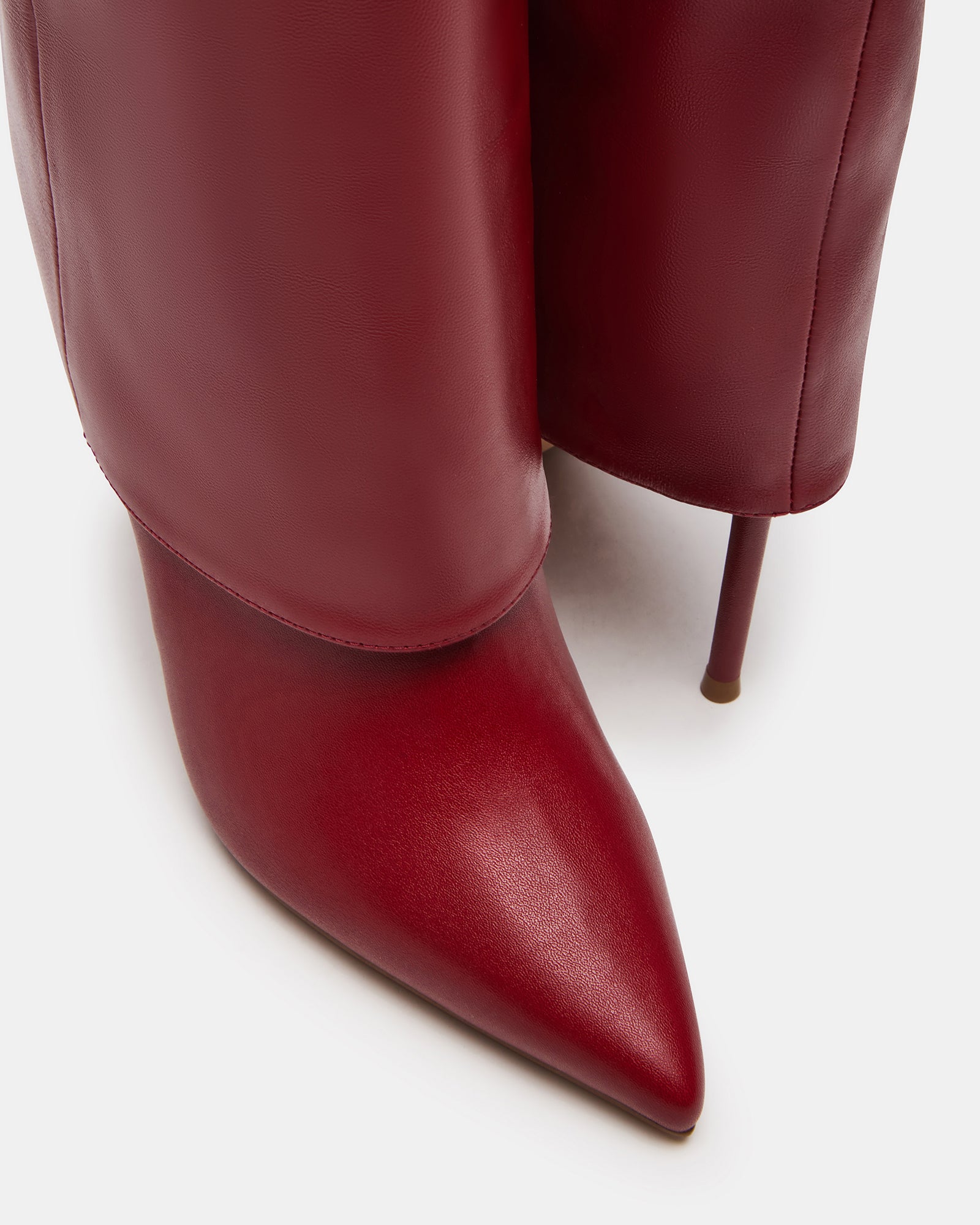 Model wearing brown knee high boots paired with fall fashion layers