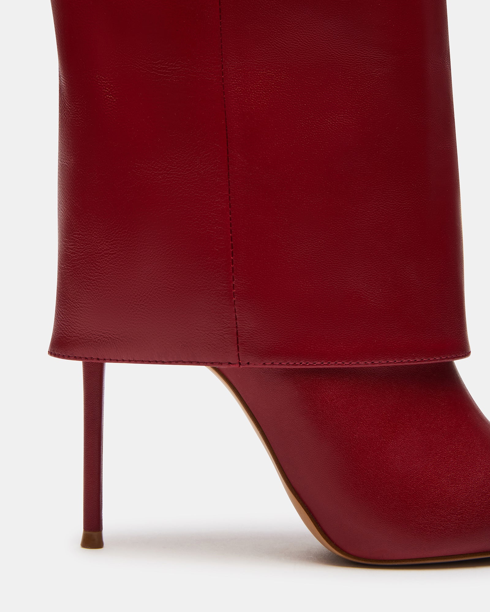 Side view of red leather boots with pointed toe and fold-over shaft