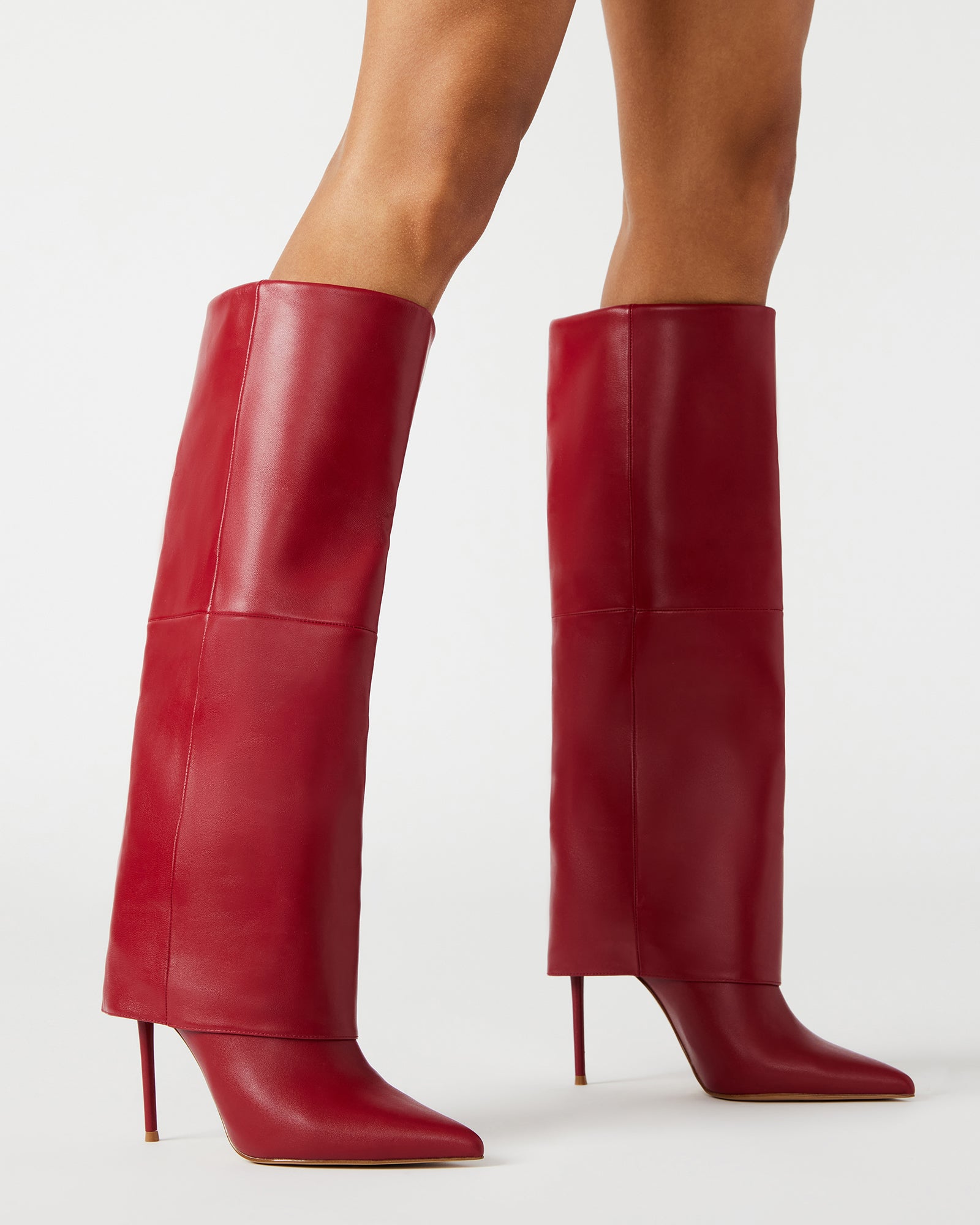 Model wearing brown knee high boots paired with fall fashion layers