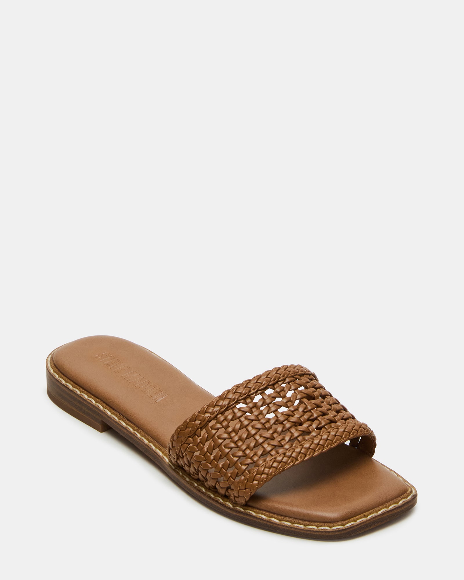 Woman wearing vegan leather slide sandals with square toe in outdoor setting
