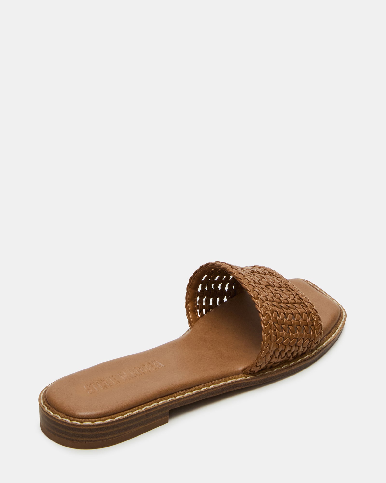 Woman wearing vegan leather slide sandals with square toe in outdoor setting