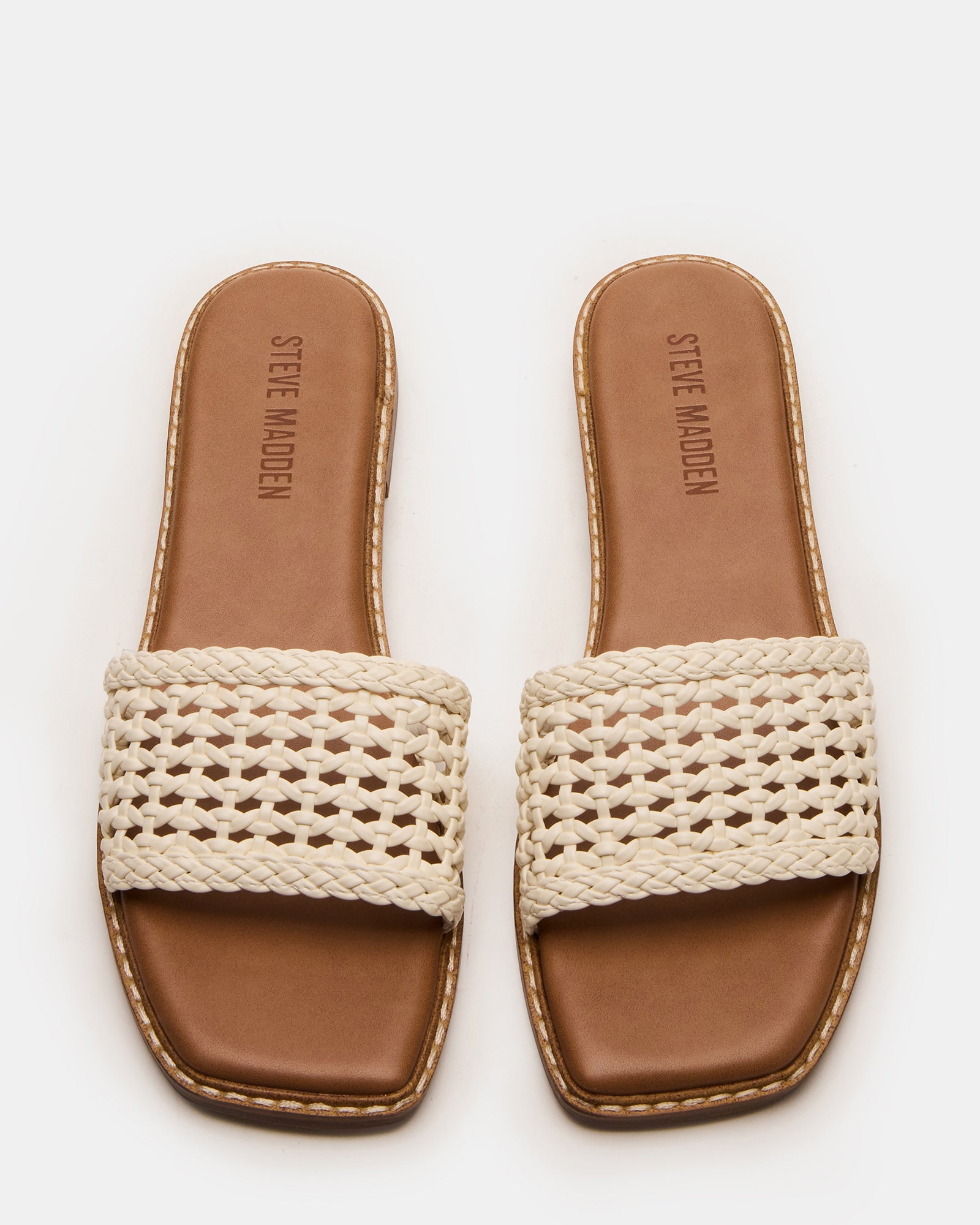 SNIDER white slides worn with cropped jeans, captured on Colorado sidewalk