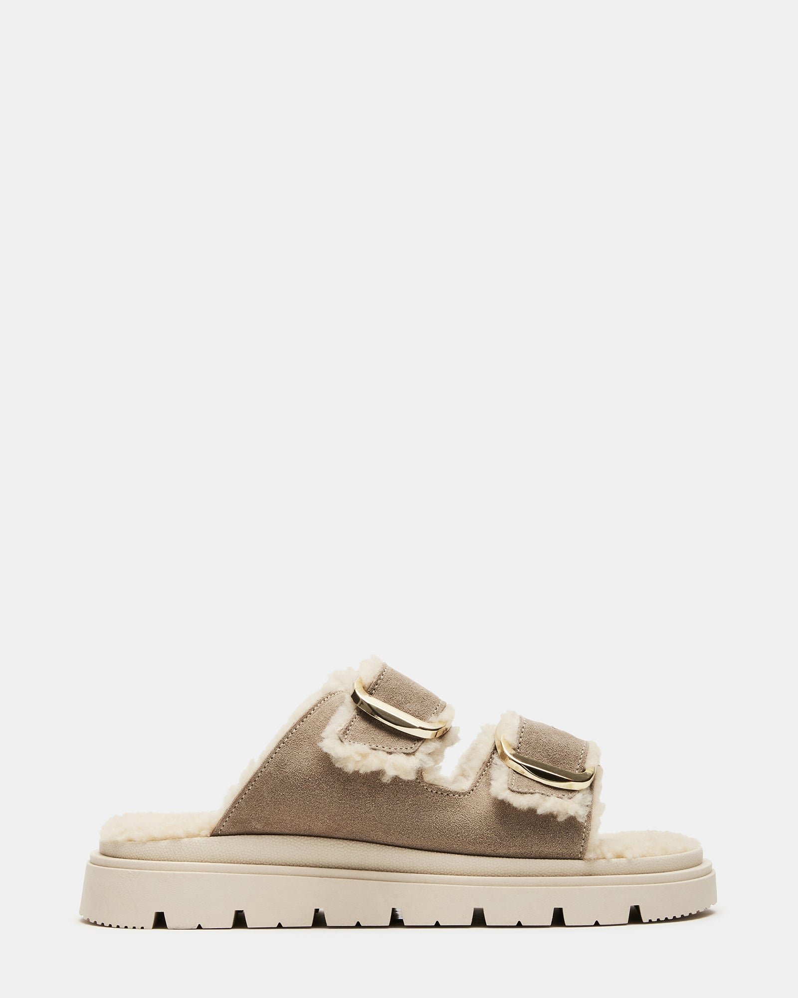 Close-up of suede straps and faux fur lining on slide sandals