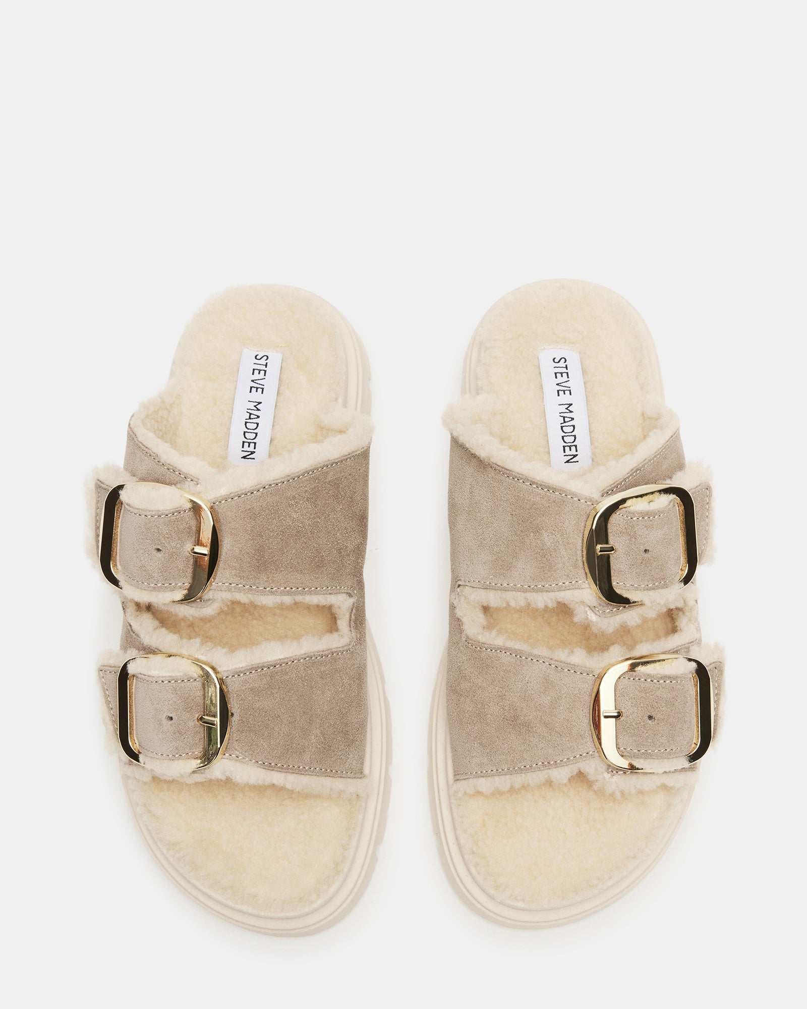Close-up of suede straps and faux fur lining on slide sandals